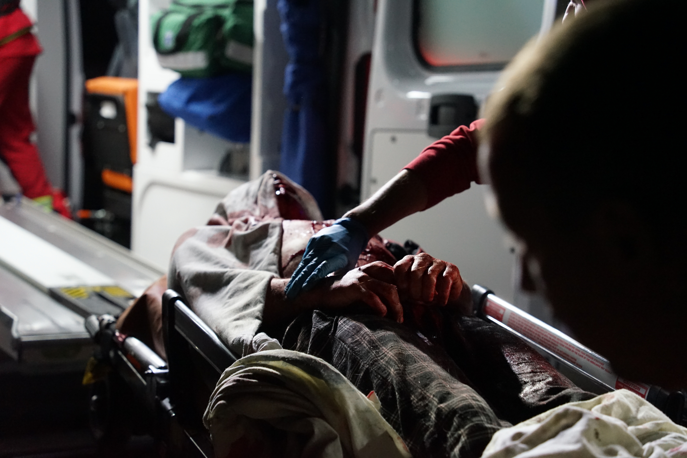 Emergency workers getting an injured person into the ambulance in the aftermath of Russian glide bomb attack on Kharkiv on September 21 / Photo: Denys Klymenko, Gwara Media