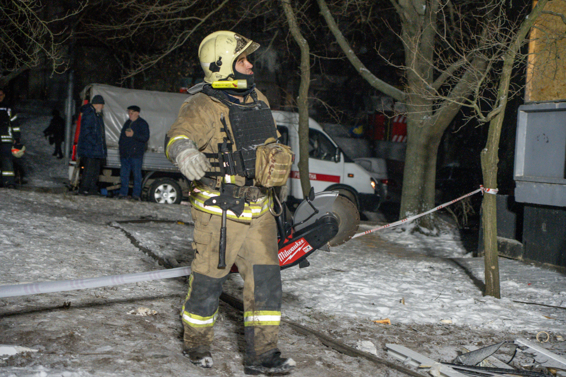 Rescuer at the impact site of Russian attack on Kharkiv on Feb 26 / Photo: Oleksandr Manchenko, Gwara Media