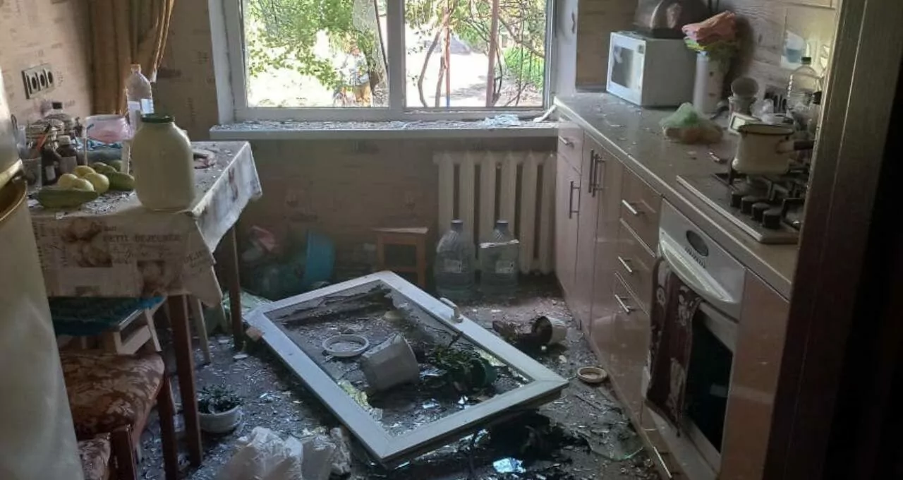Consequences of Russian shelling of Borova - a blown-out window in the kitchen, broken glass lying around