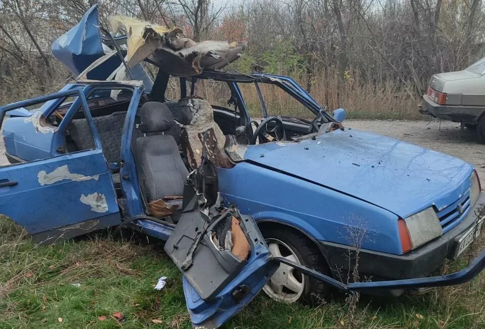 Blue car with most of it burned and broken off by Russian FPV drone strike