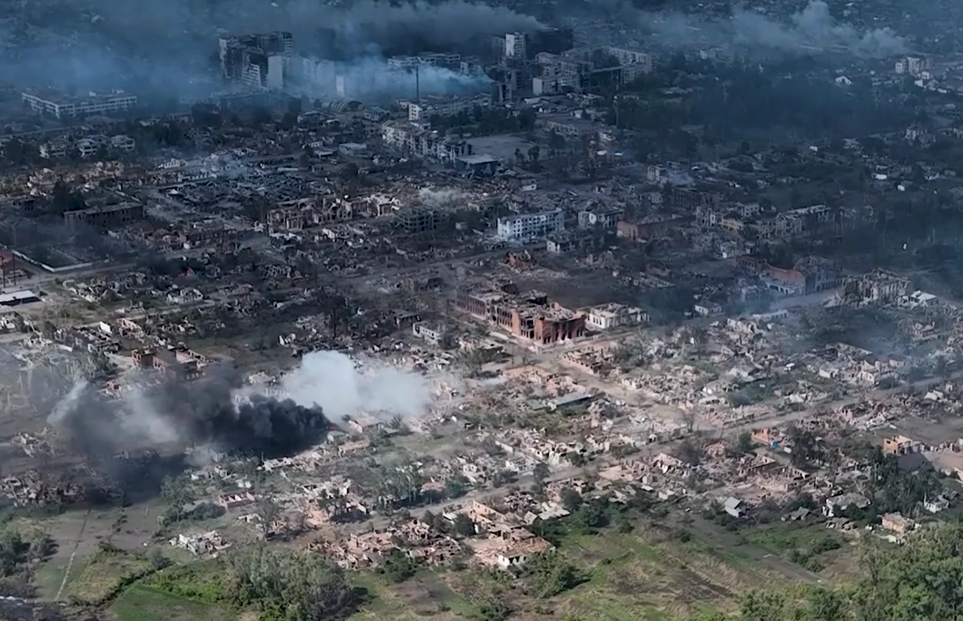 Vovchansk of Kharkiv Oblast - destroyed city, smoke rising to the sky, view from above