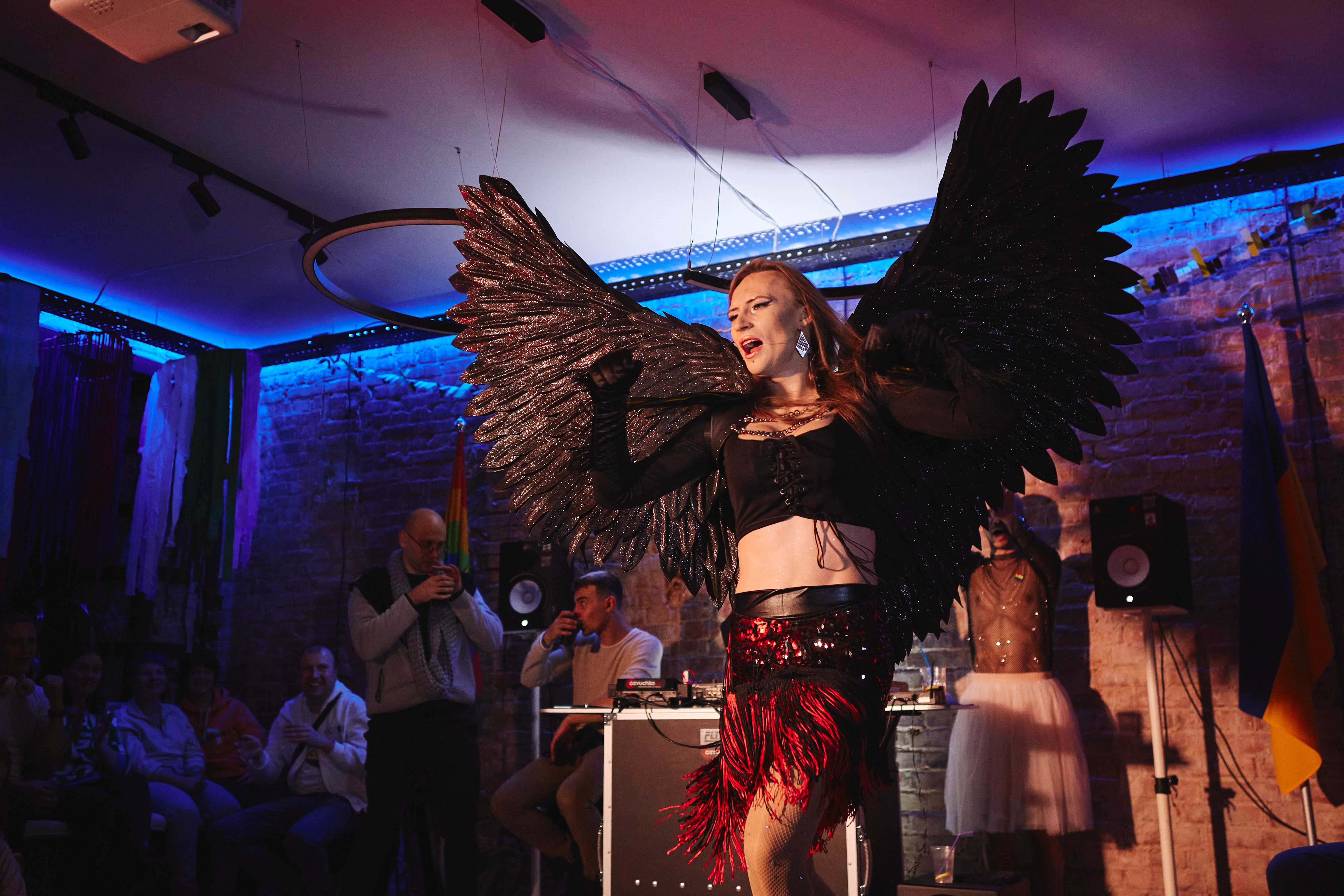 Diana Dark in a costume with large wings