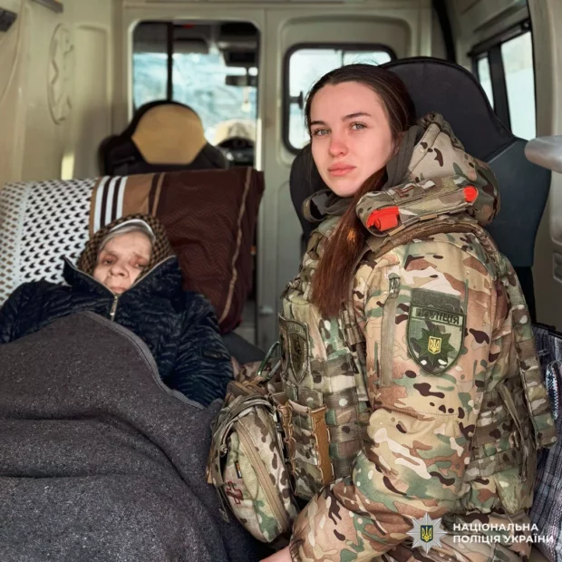 Police worker of White Angel special unit and a bedridden woman who is being evacuated