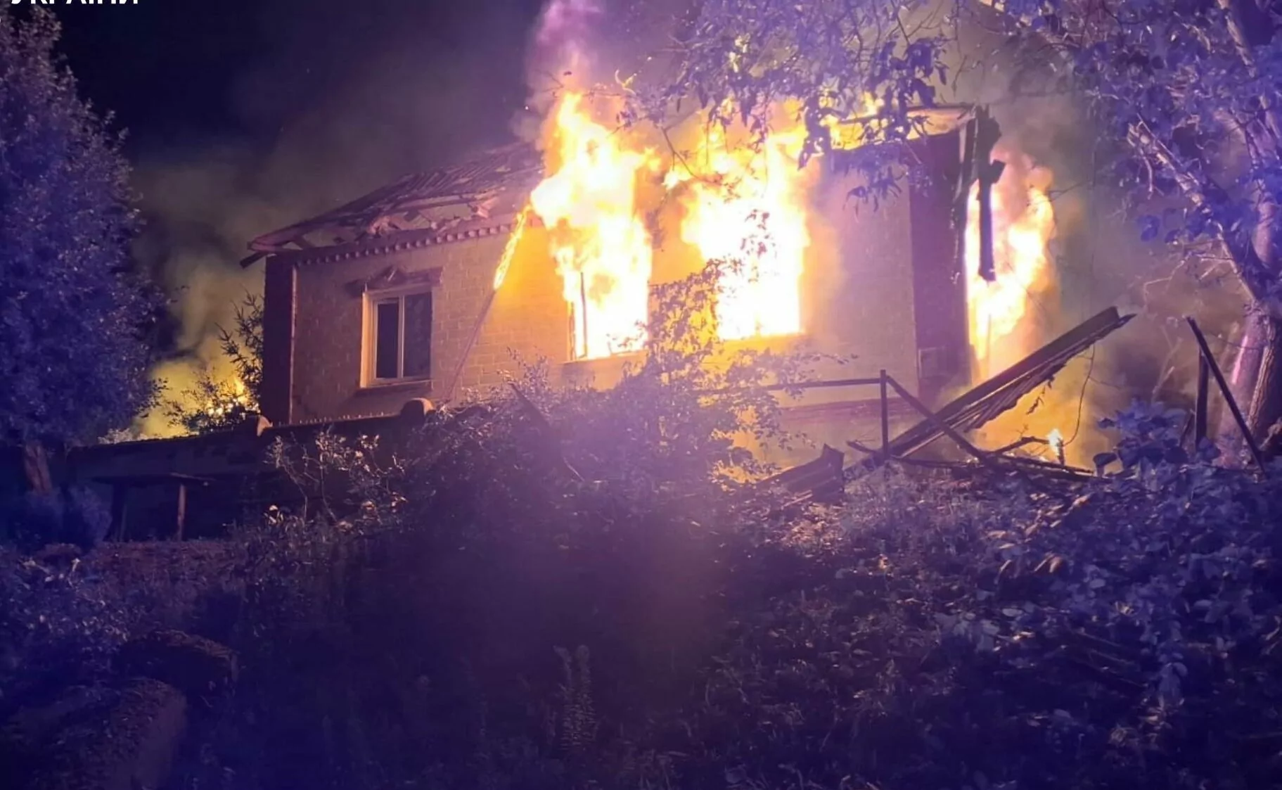 A house burning in the aftermath of Russian attack on Zmiiv