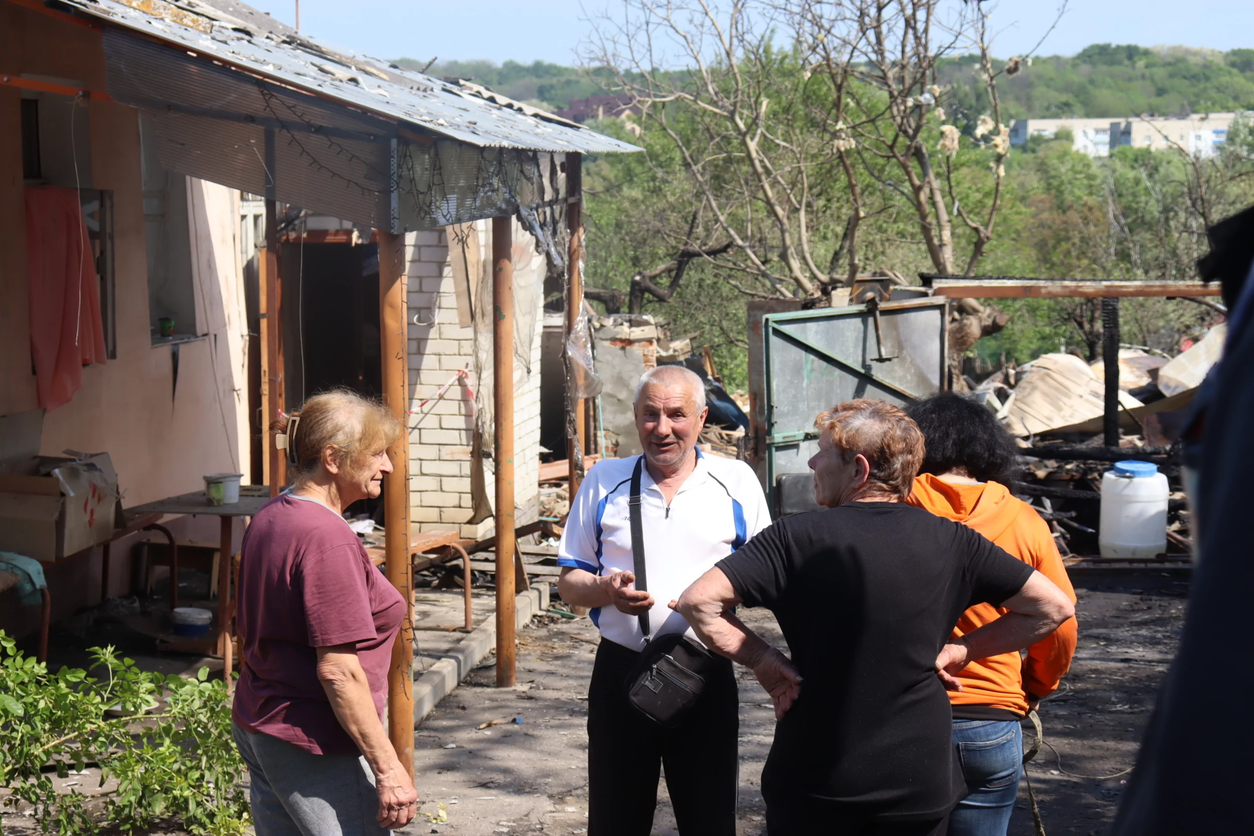 Oleksii and his relatives in his yard in Kulynychi, a village Russia attacked with a drone strike on May 21, 2024 / Photo: Yana Sliemzina for Gwara Media