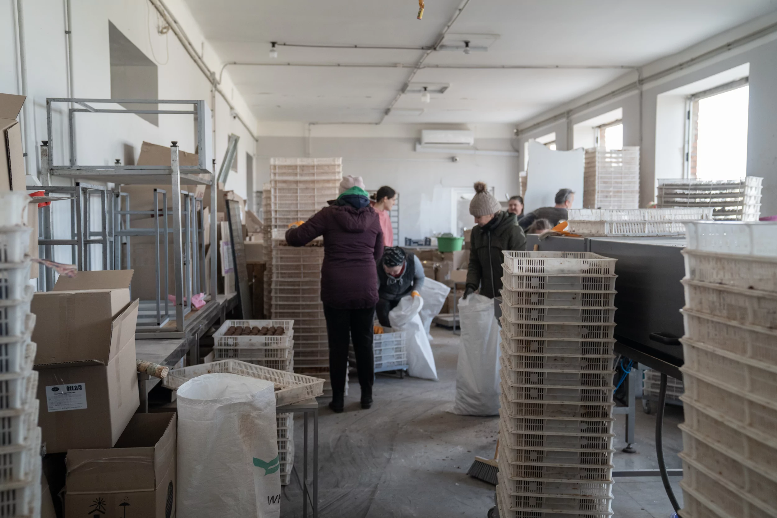 Workers are sorting the products after a Russian drone attack