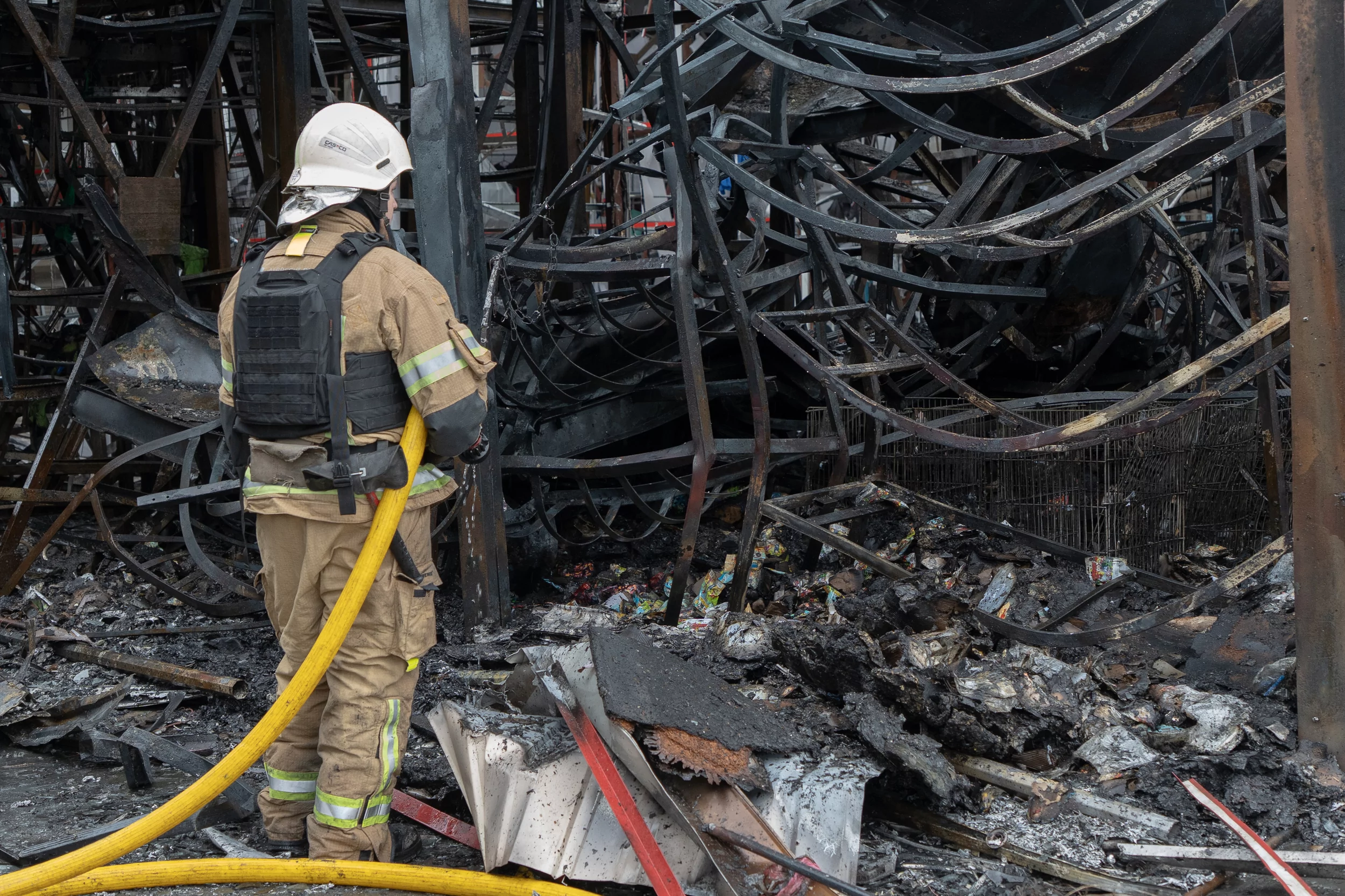 Firefighter extinguishes a fire on the Barabashovo market in Kharkiv after Russian attack on May 6