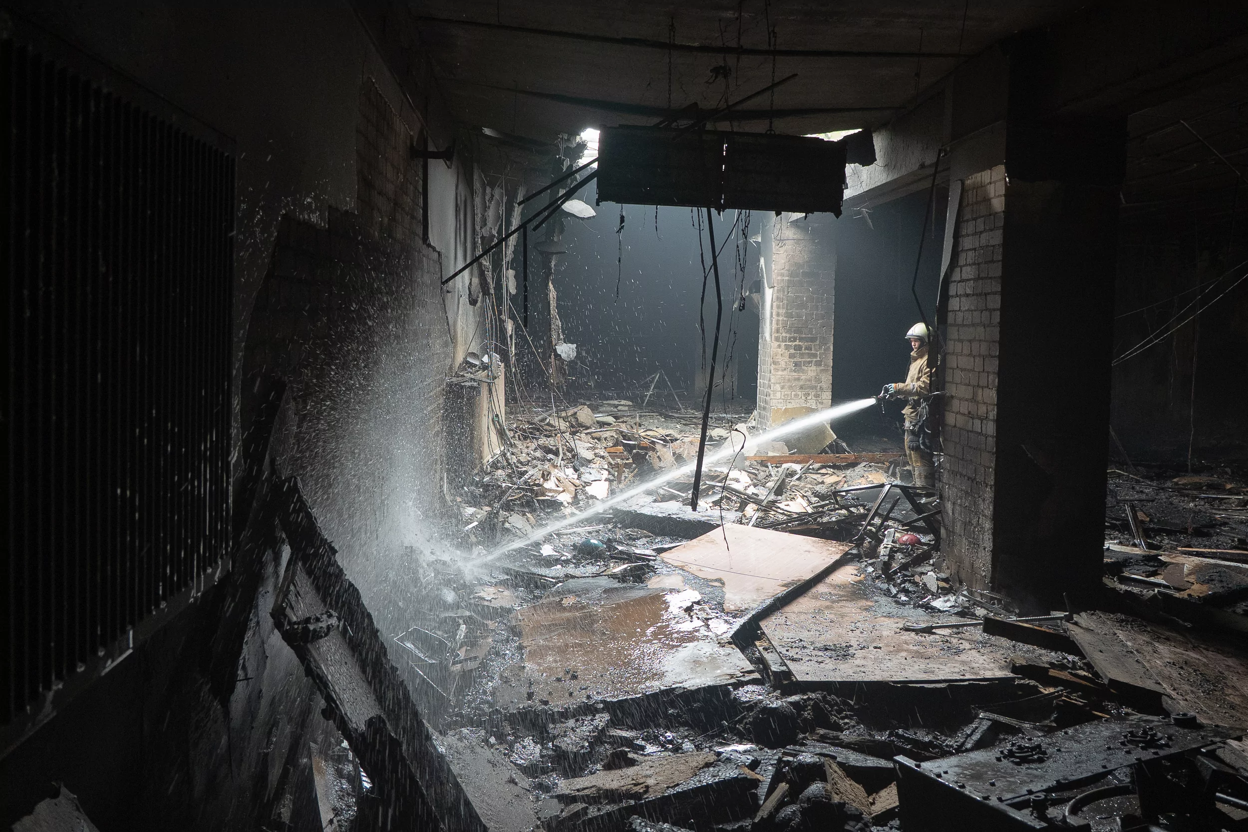 Firefighter extinguishes a fire at restaurant building in Kyivskyi district after Russian attack on May 6