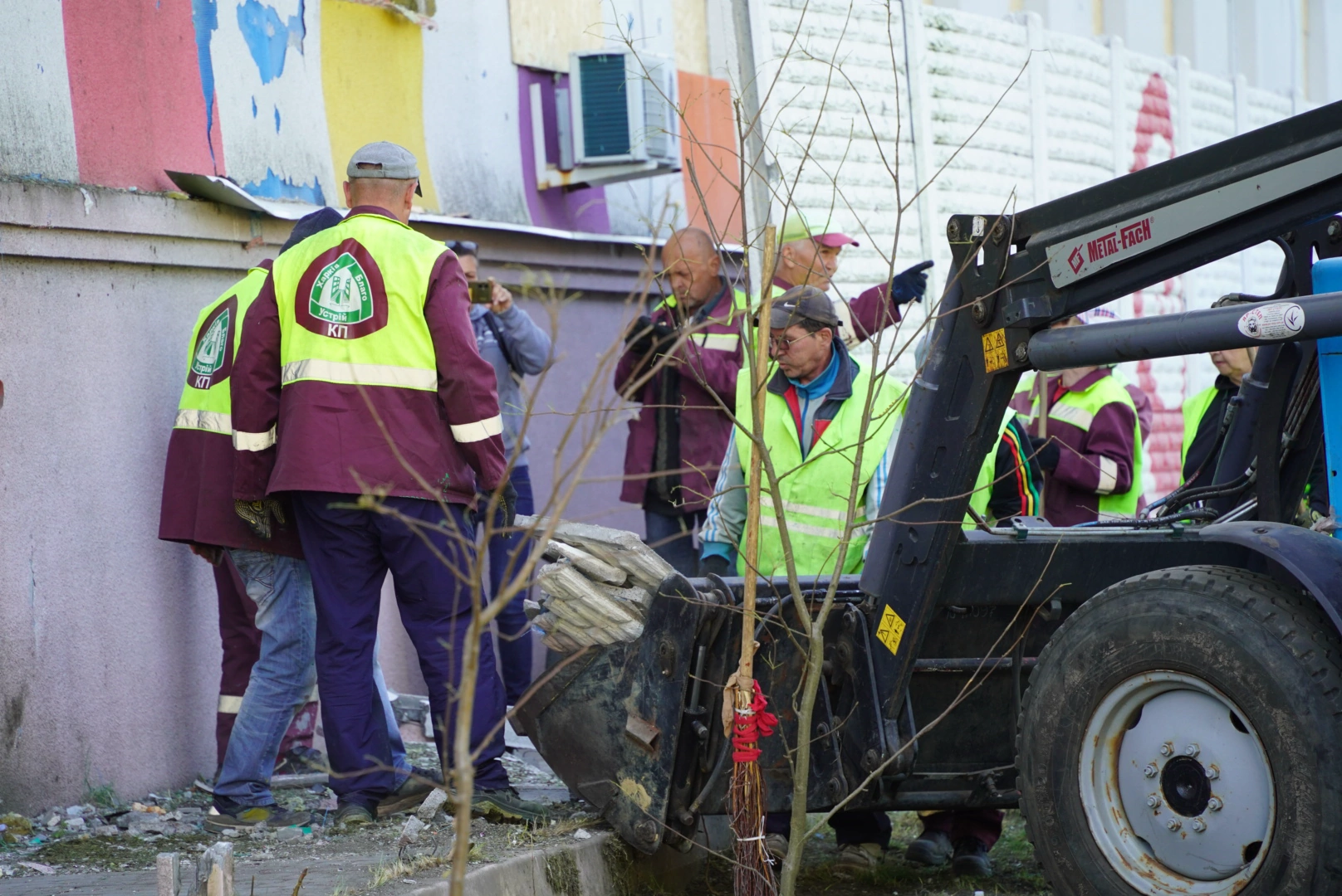Municipal workers cleaning up the impact site of one of the Russian drone strikes on Kharkiv on May 2, 2025