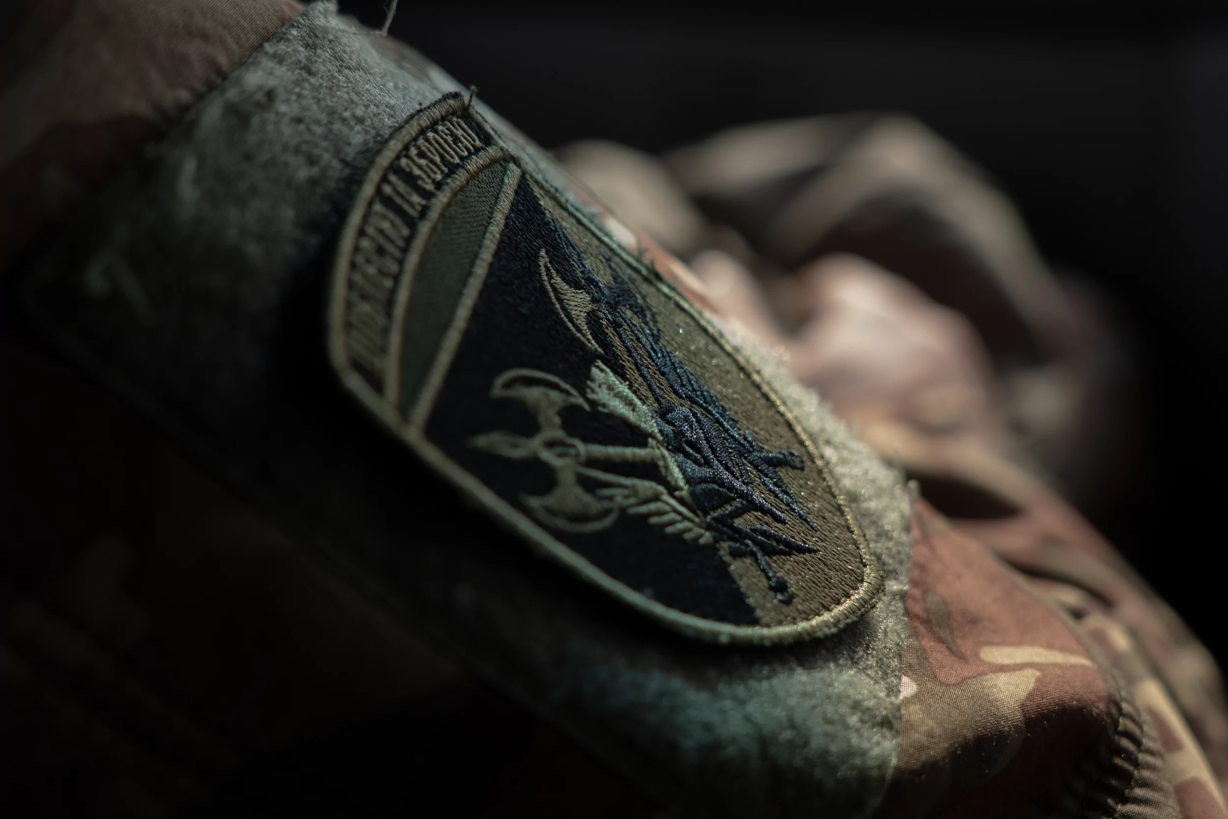 The chevron “With Honor and Weapon”