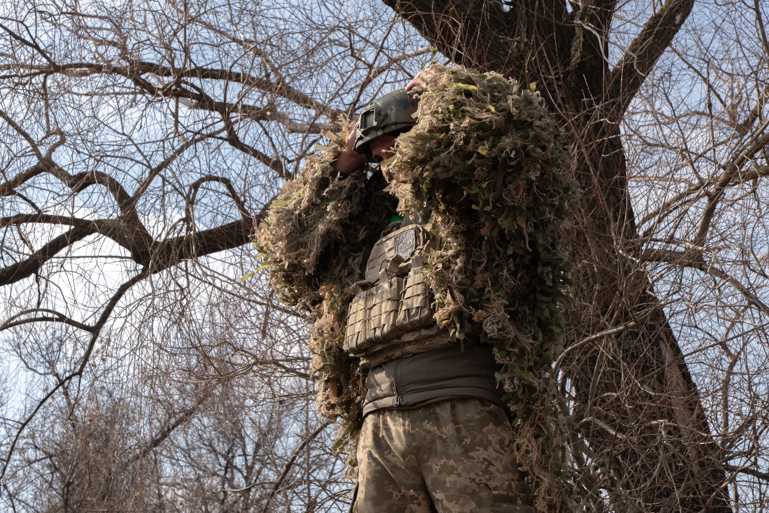 A sniper in a ghillie suit