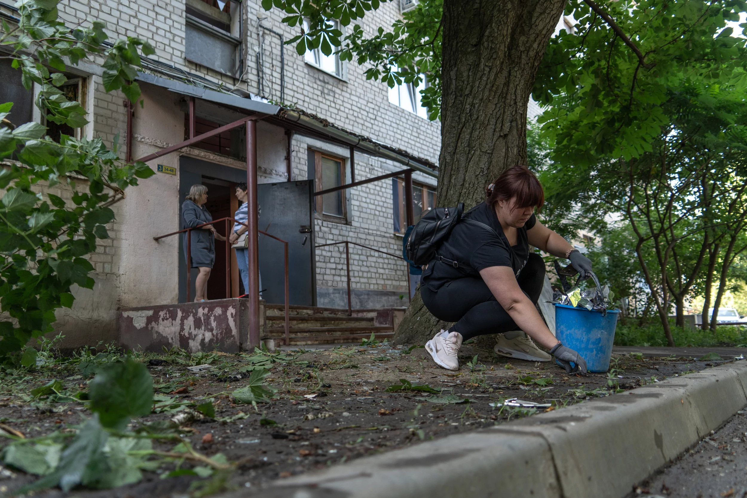 Locals and utility services are working on the impact site in Slobidskyi district after Russian attack on June 11