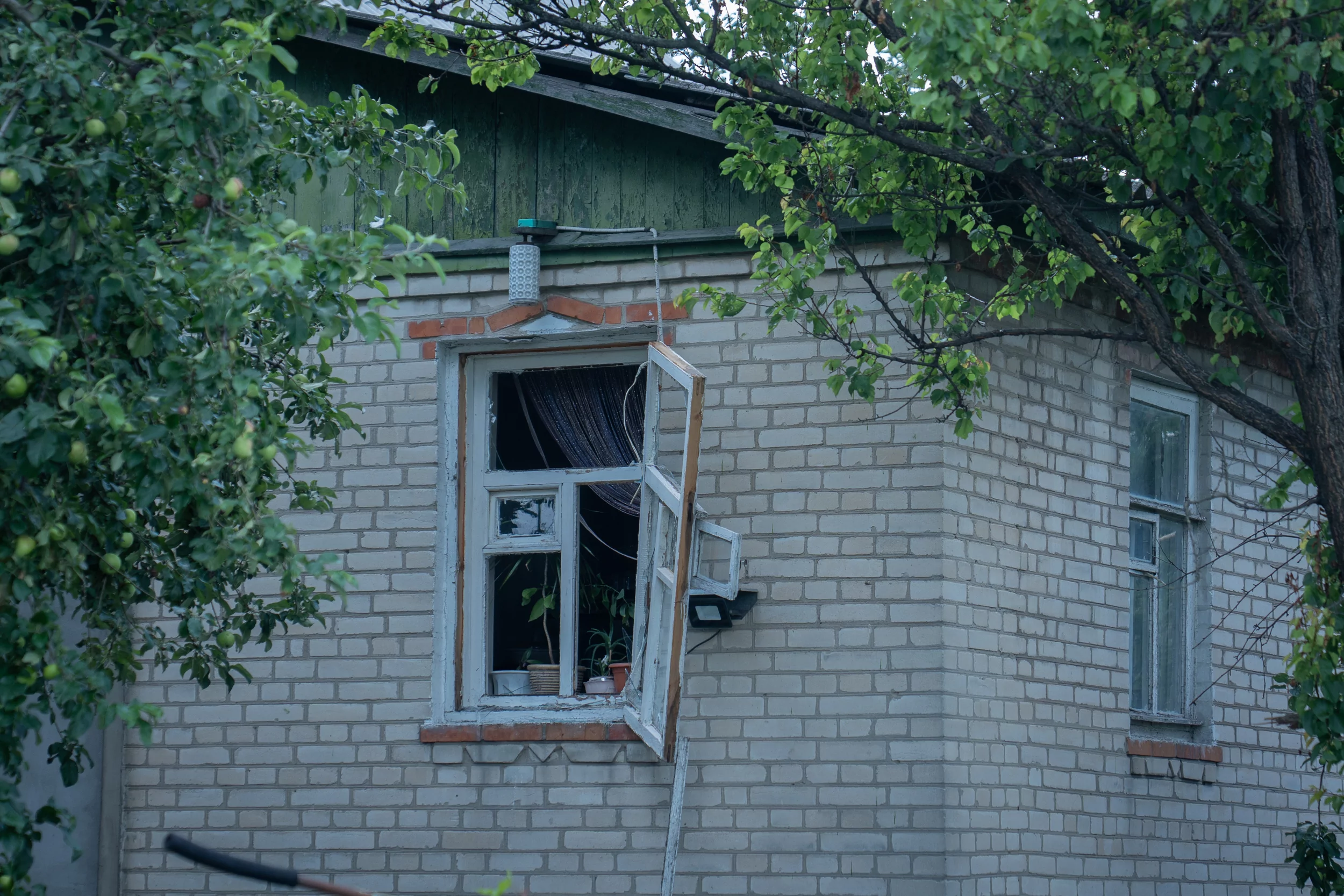 Broken windows in damaged house after Russian drone attack in Pisochyn on June 30