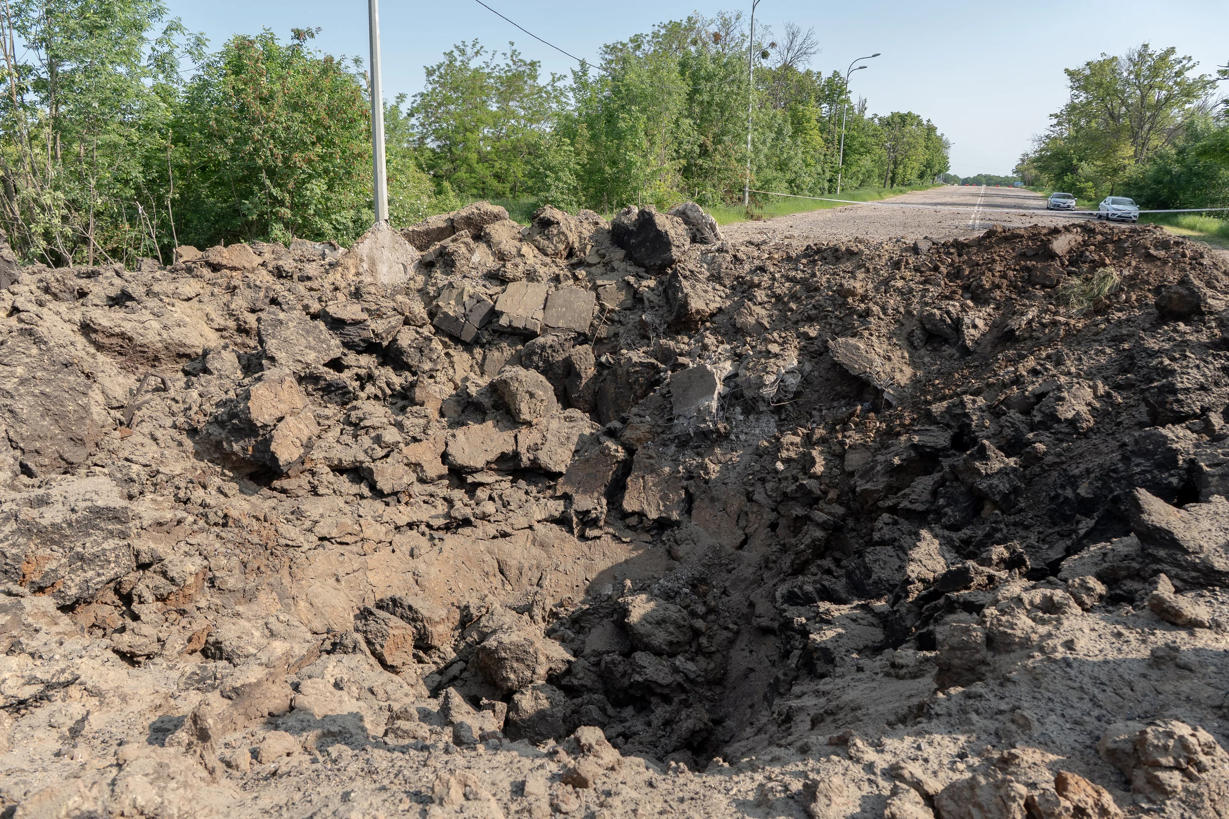 Hole in the road after Russian attack in Kyivskyi district on June 2
