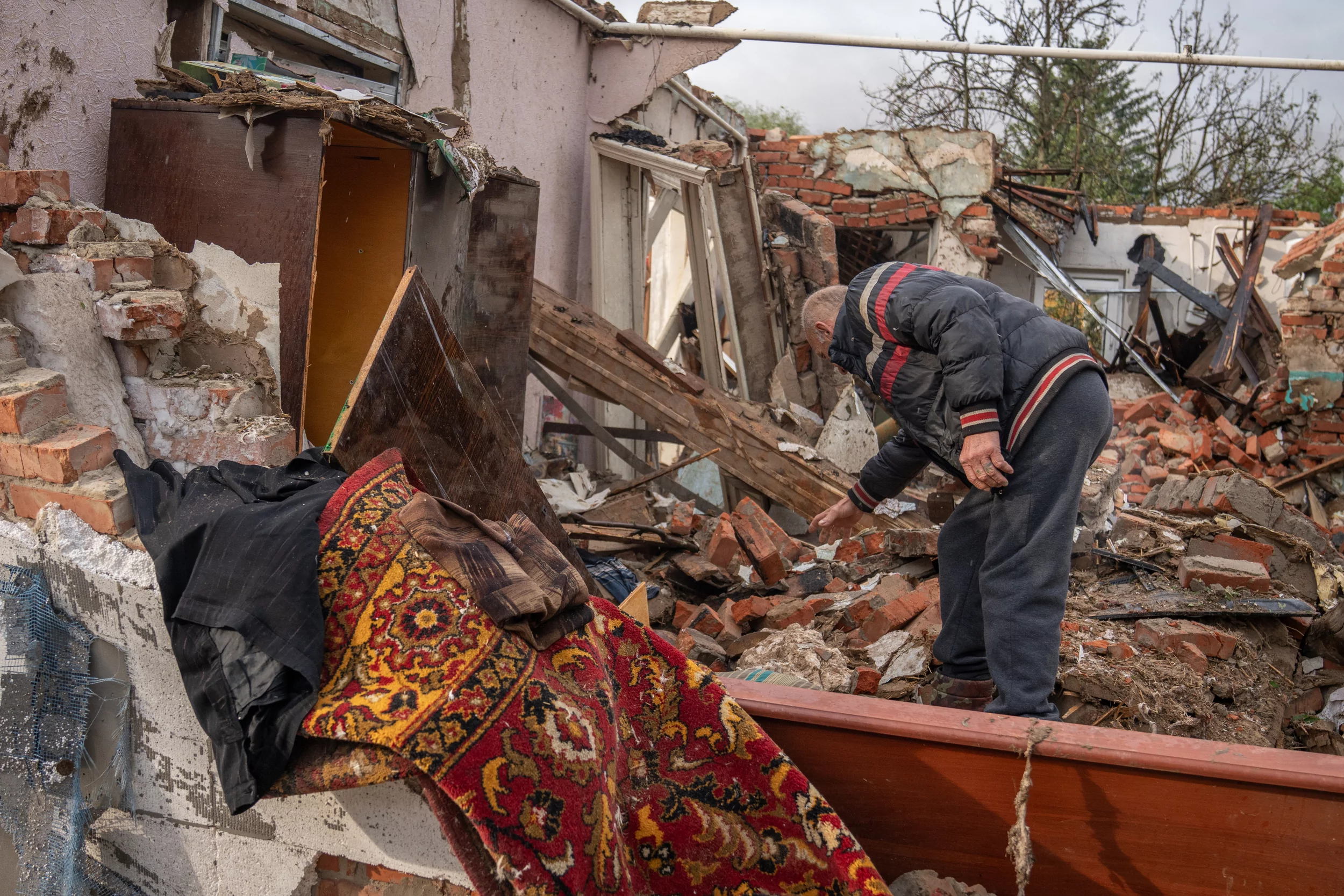 Local sorting out the debris of the house destroyed by Russian attack on Kyivskyi district on June 7, 2025
