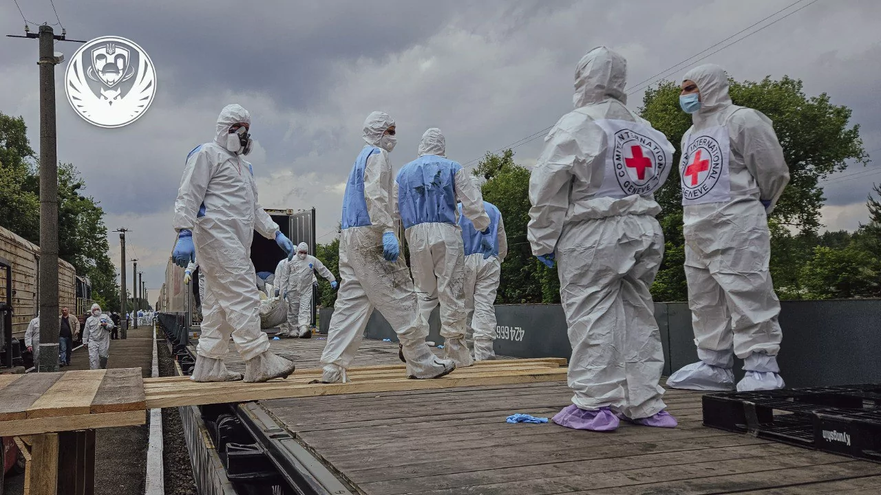 Red Cross personnel assist in a body repatriation operation