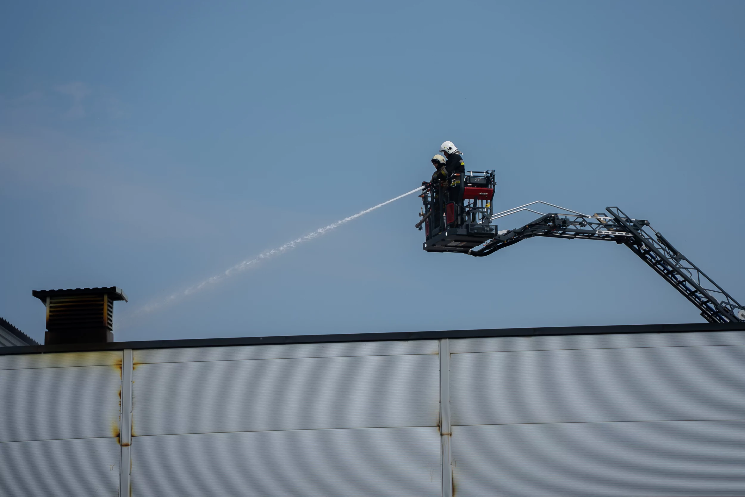 Firefighters extinguish the fire after Russian attack on Vasyshchevo village in Kharkiv outskirts on July 30
