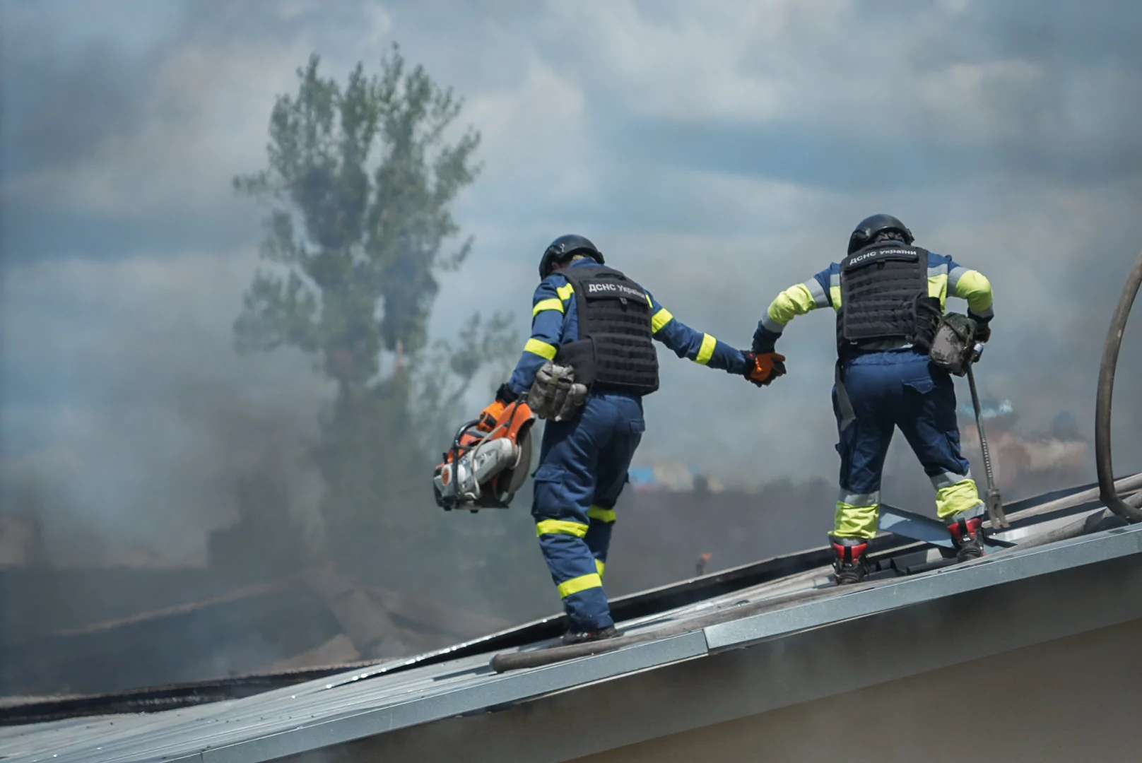 Firefighters extinguish a fire at a factory in Shevchenkivskyi district after Russian attack on July 24