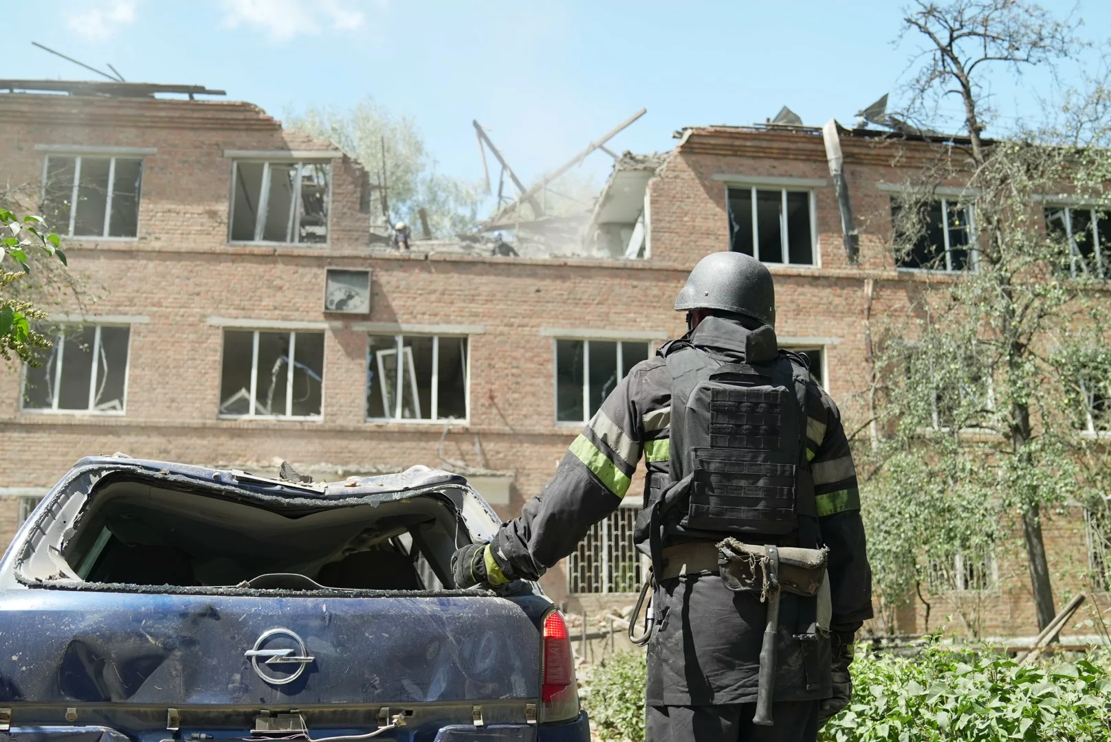 State Emergency Service worker near damaged building of tuberculosis hospital in Kharkiv after Russian attack on July 25