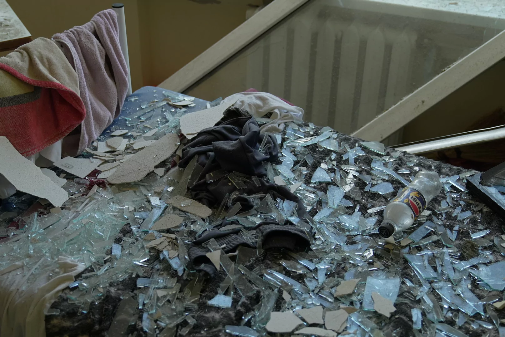 Bed covered with glass in damaged tuberculosis hospital in Kharkiv after Russian attack on July 25