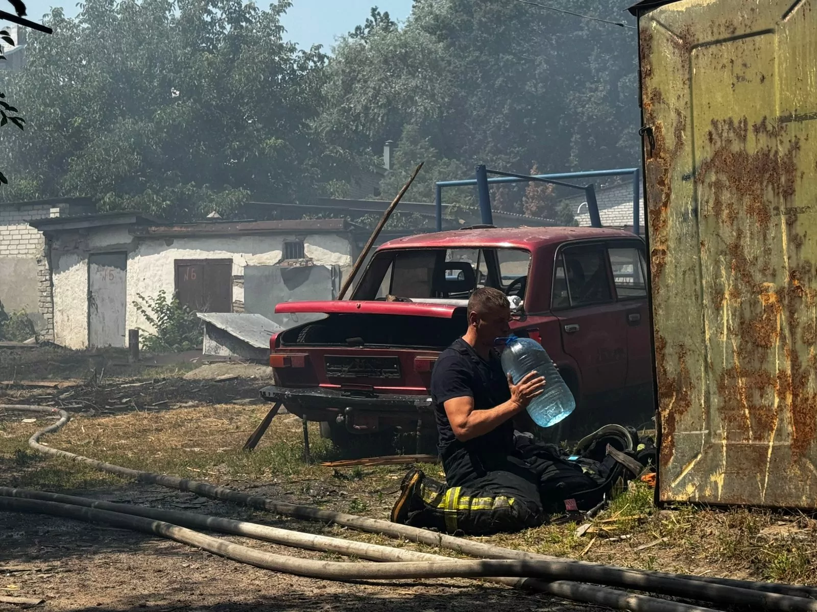 Rescuer drinking in the middle of dealing with consequences of Russian drone attack on Kharkiv
