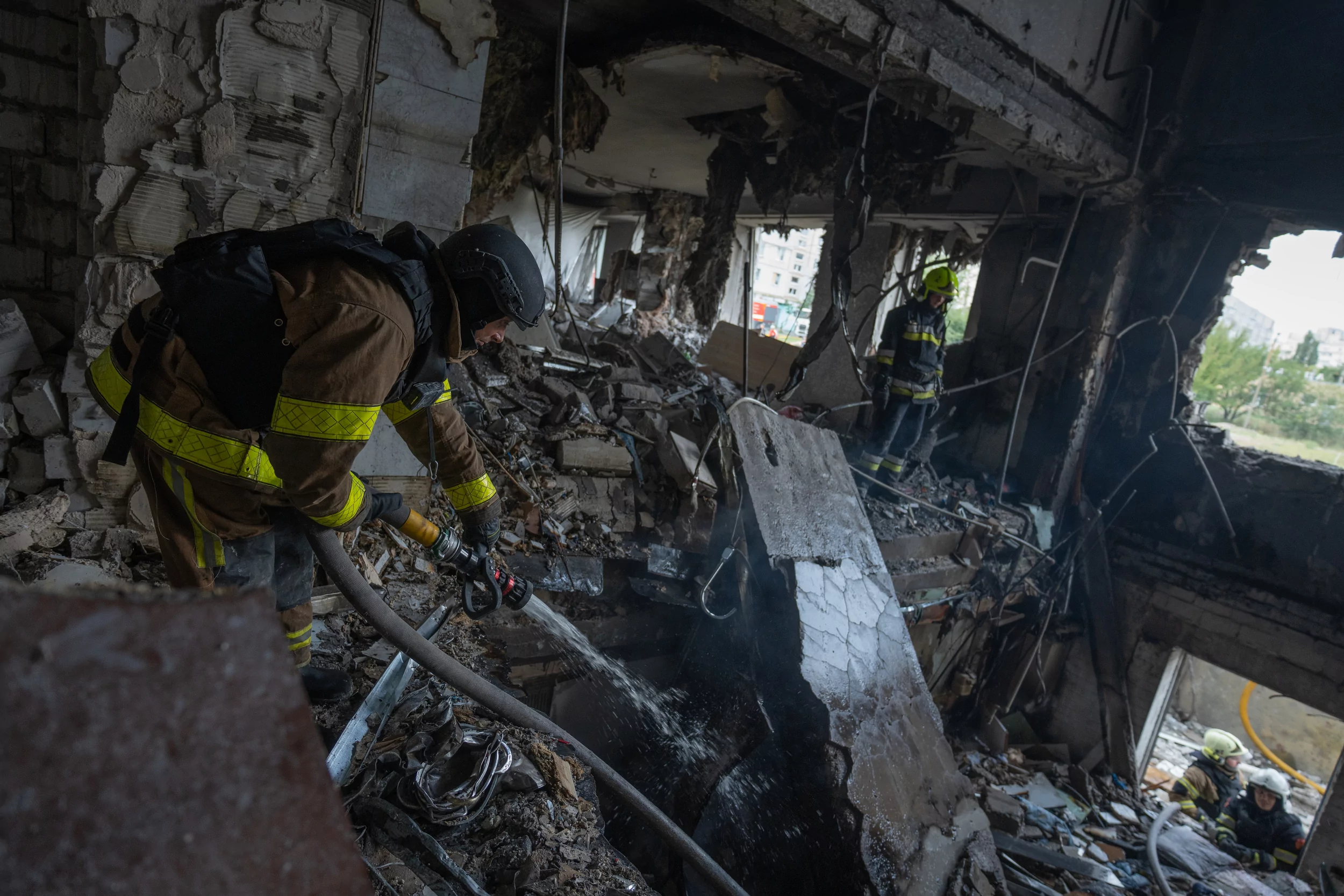 Rescuers are putting out fires and searching through the rubble for people after Russian hit a residential apartment building with Geran-2 drones