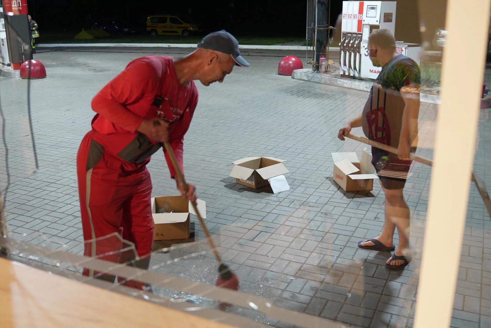 Workers at a gas station remove damage caused by the Russian attack on August 5