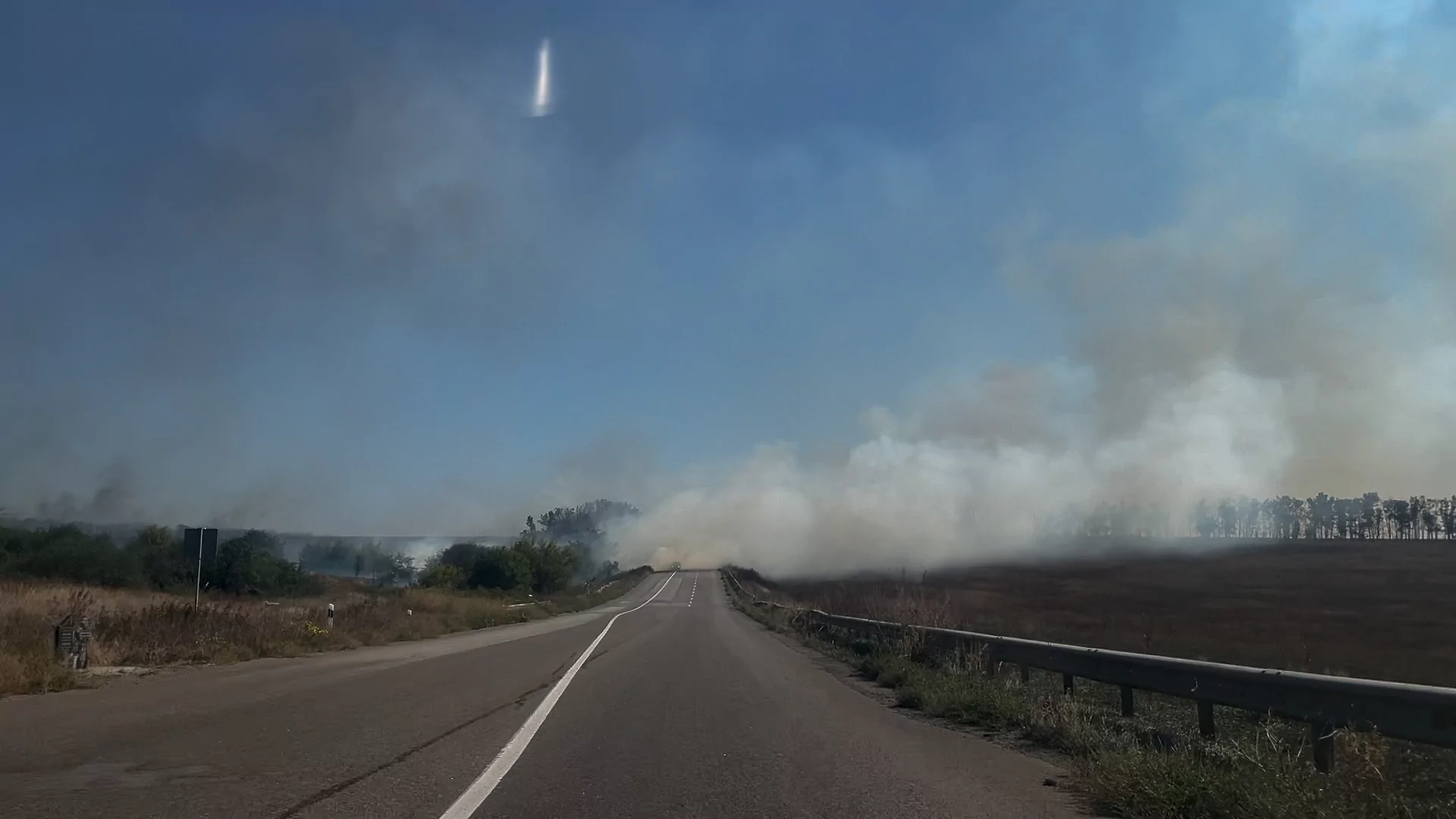 Izium-Sloviansk highway with a smoke rising from the hills burnt by Russian attacks. Sep. 7, 2025
