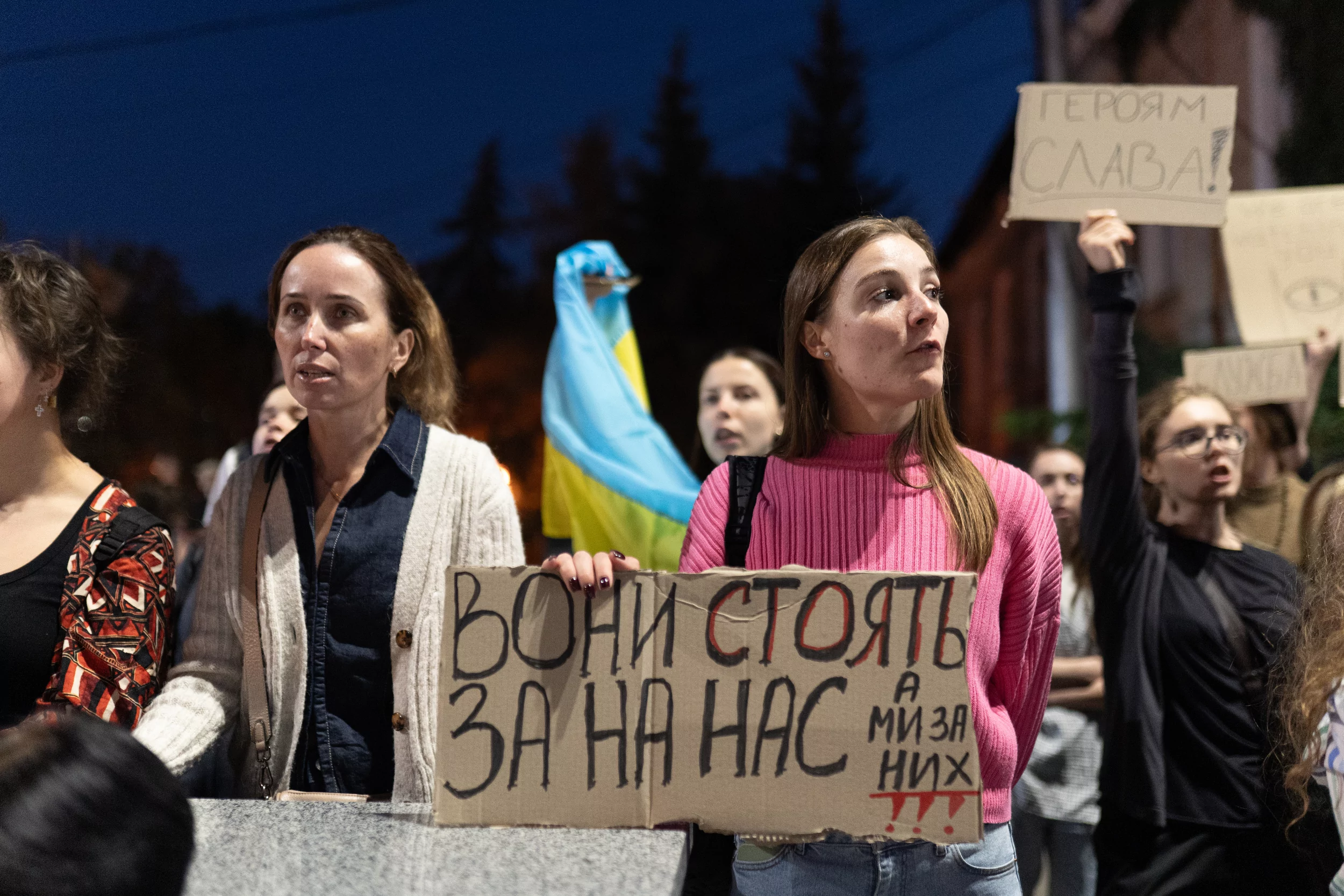 A protester holding a sign reading “They stand for us, and we stand for them” at a protest in Kharkiv on September 7