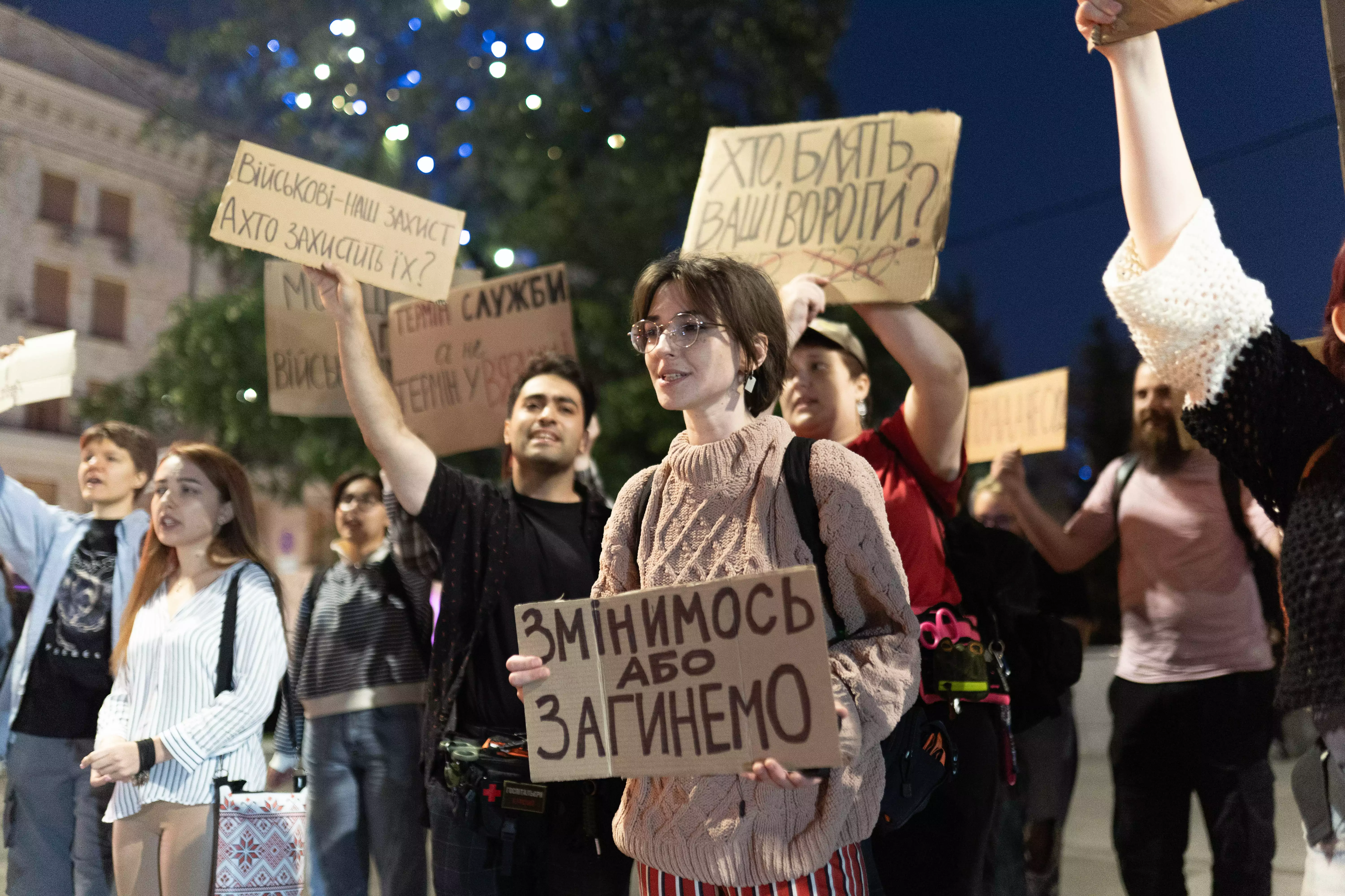 A protester holding a sign reading “We will change or we will die” at a protest in Kharkiv on September 7