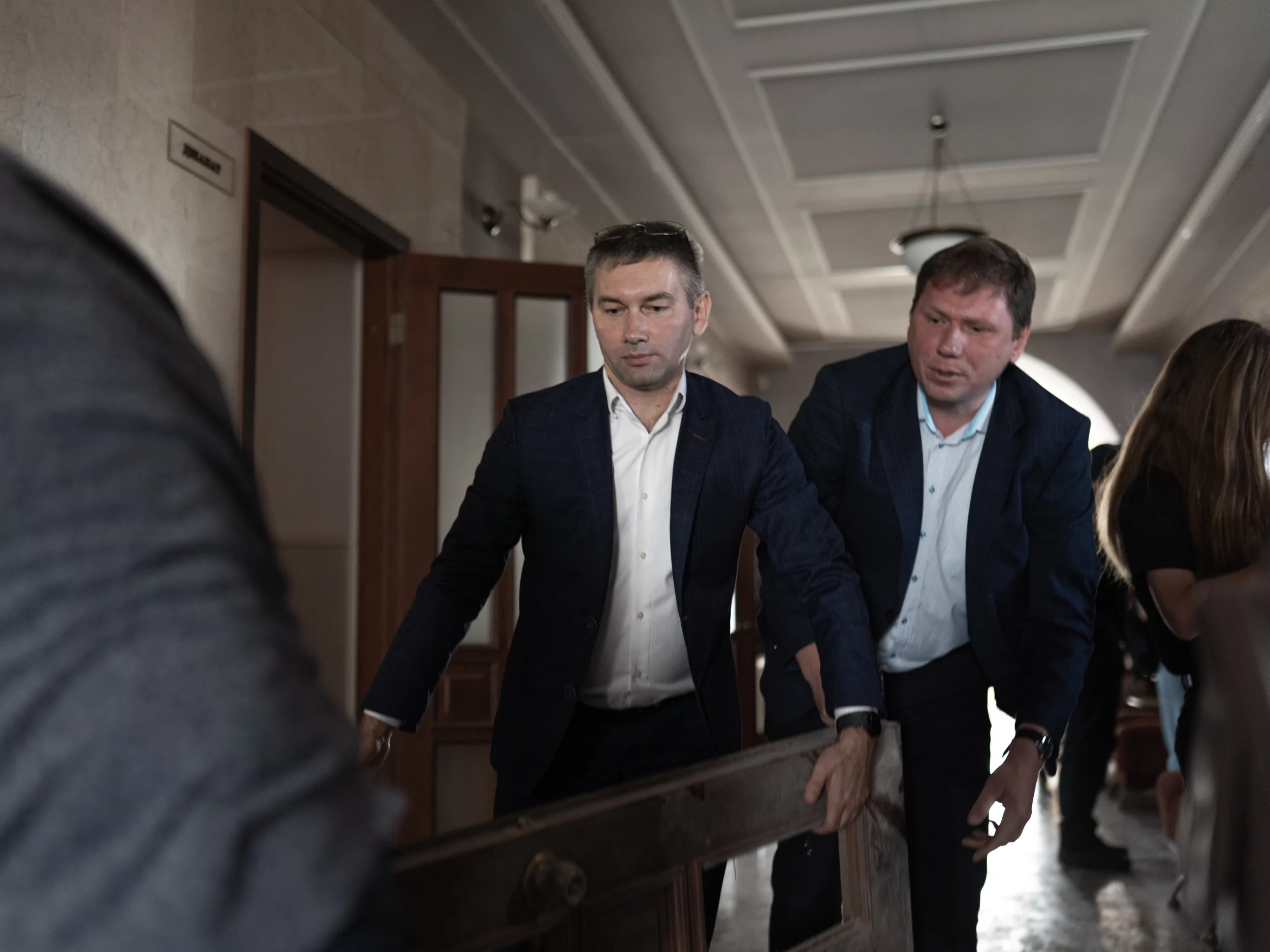 University employees carry out doors broken after Russian attack on Kharkiv on Sep. 16
