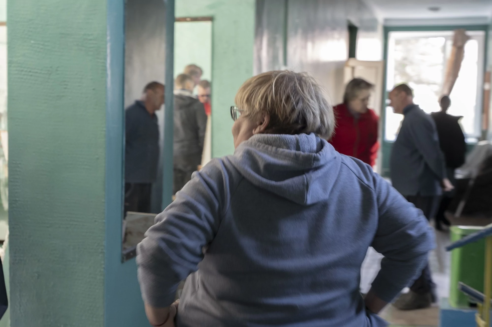 Maryna, the director of the Center for Children's and Youth Creativity, is cleaning the building while leading her team.