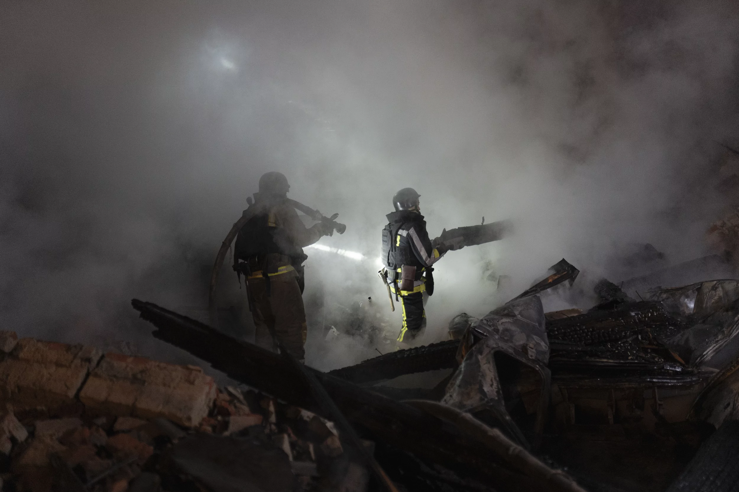 Firefighters extinguish a fire after Russian attack on hospital in Kharkiv on Oct. 14