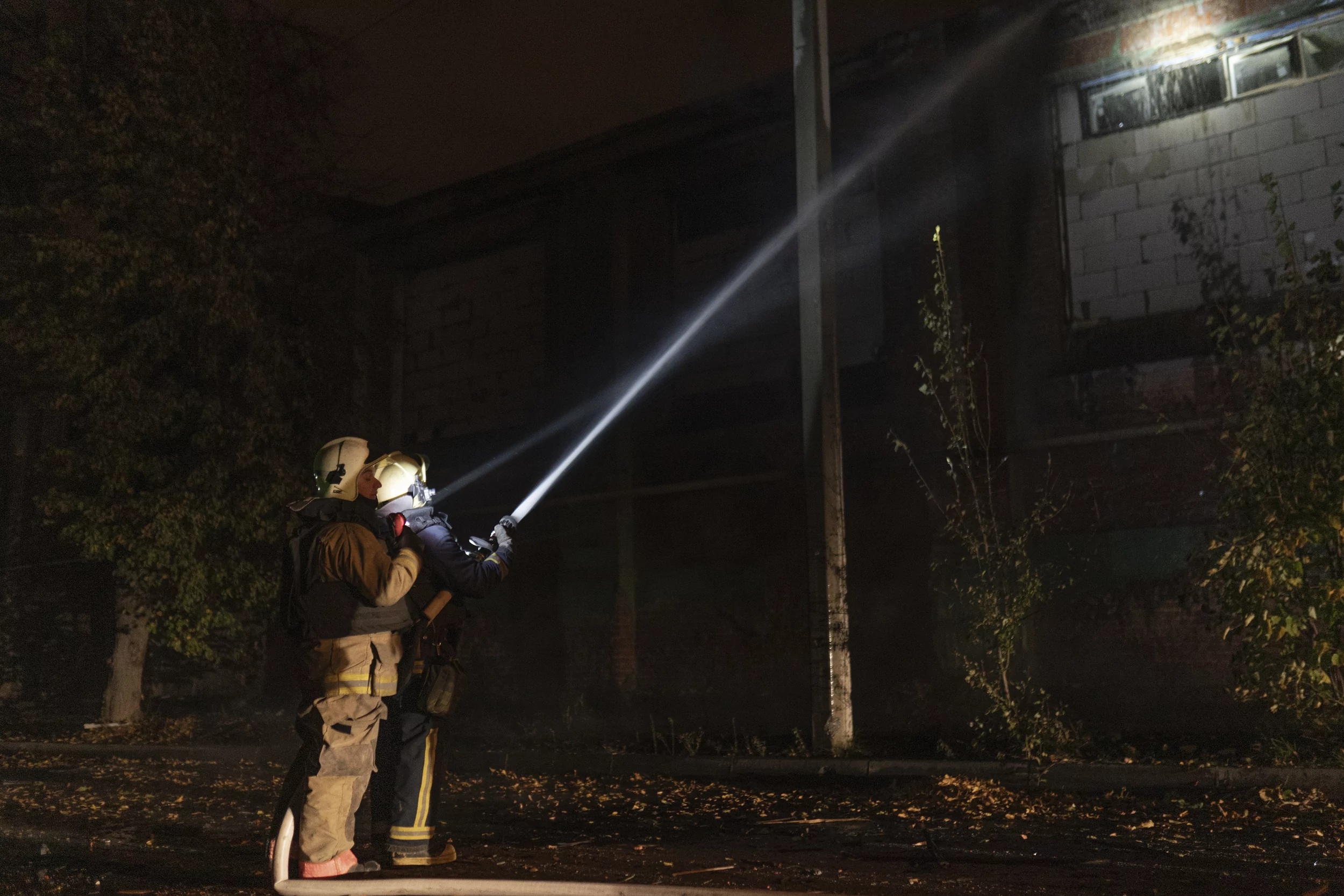 Firefighters extinguish a fire after Russian attack on hospital in Kharkiv on Oct. 14