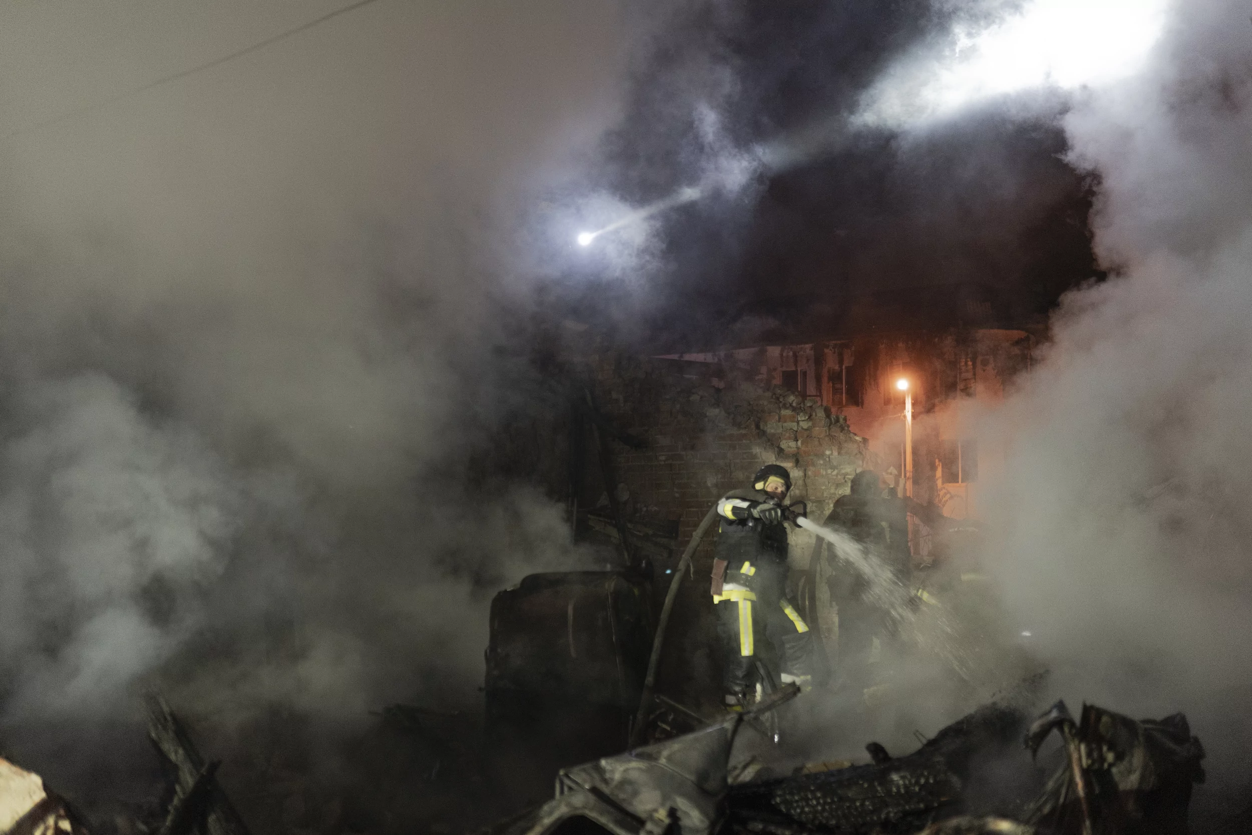 Firefighters extinguish a fire after Russian attack on hospital in Kharkiv on Oct. 14