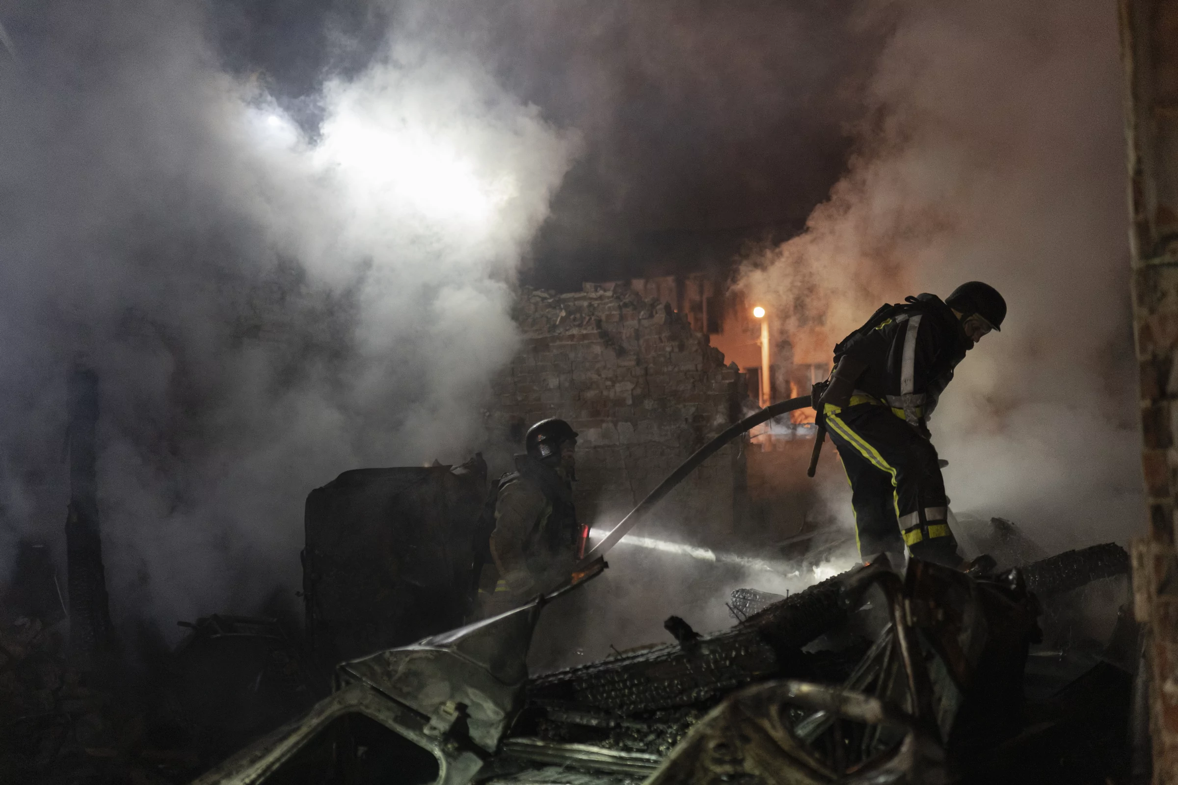 Emergency services putting out fire that broke out in the aftermath of Russian glide bomb strike near the hospital in Saltivskyi district of Kharkiv