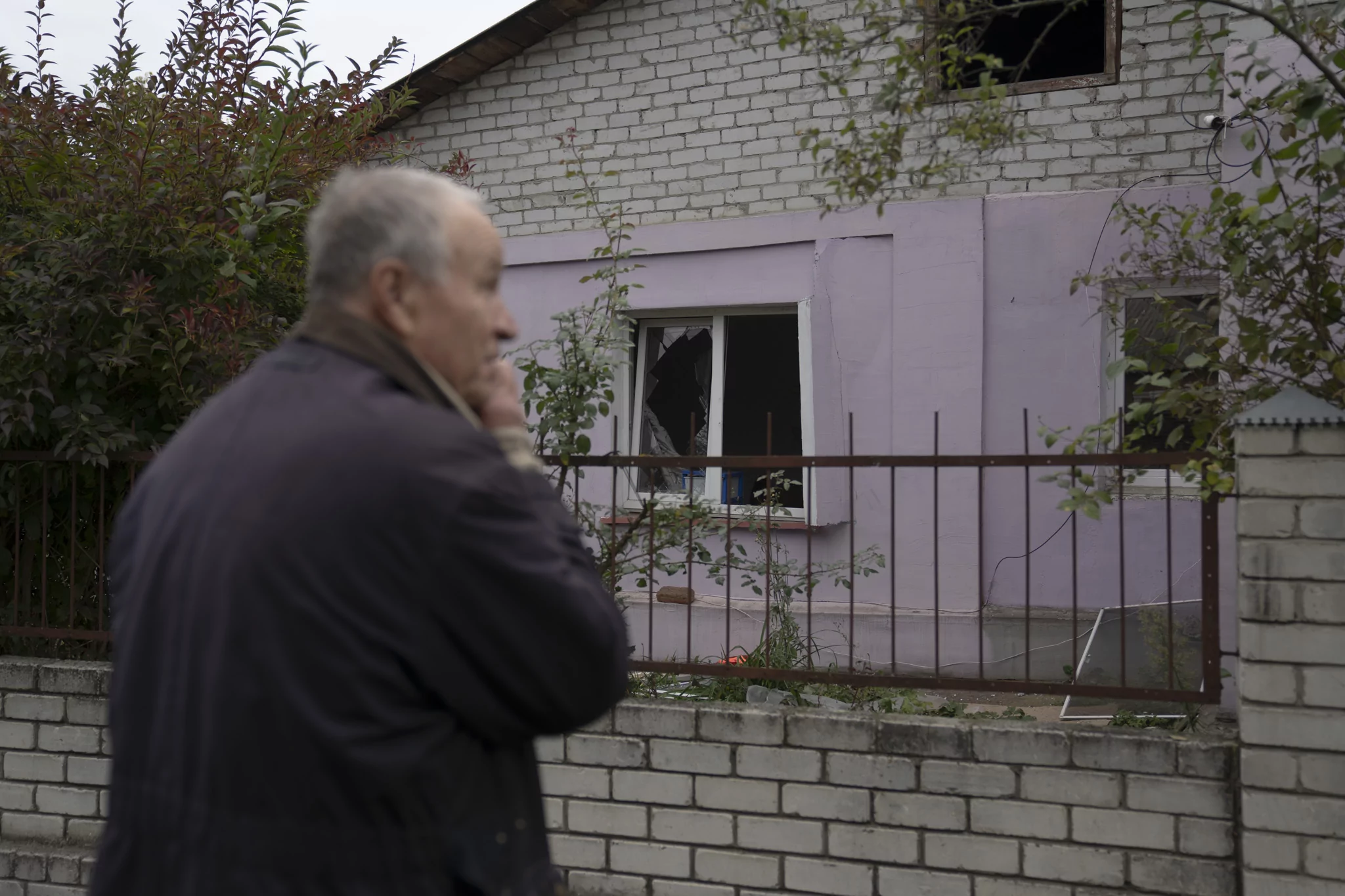 Man looking on damaged house after Russian attack on Novobavarskyi district of Kharkiv on Oct. 5