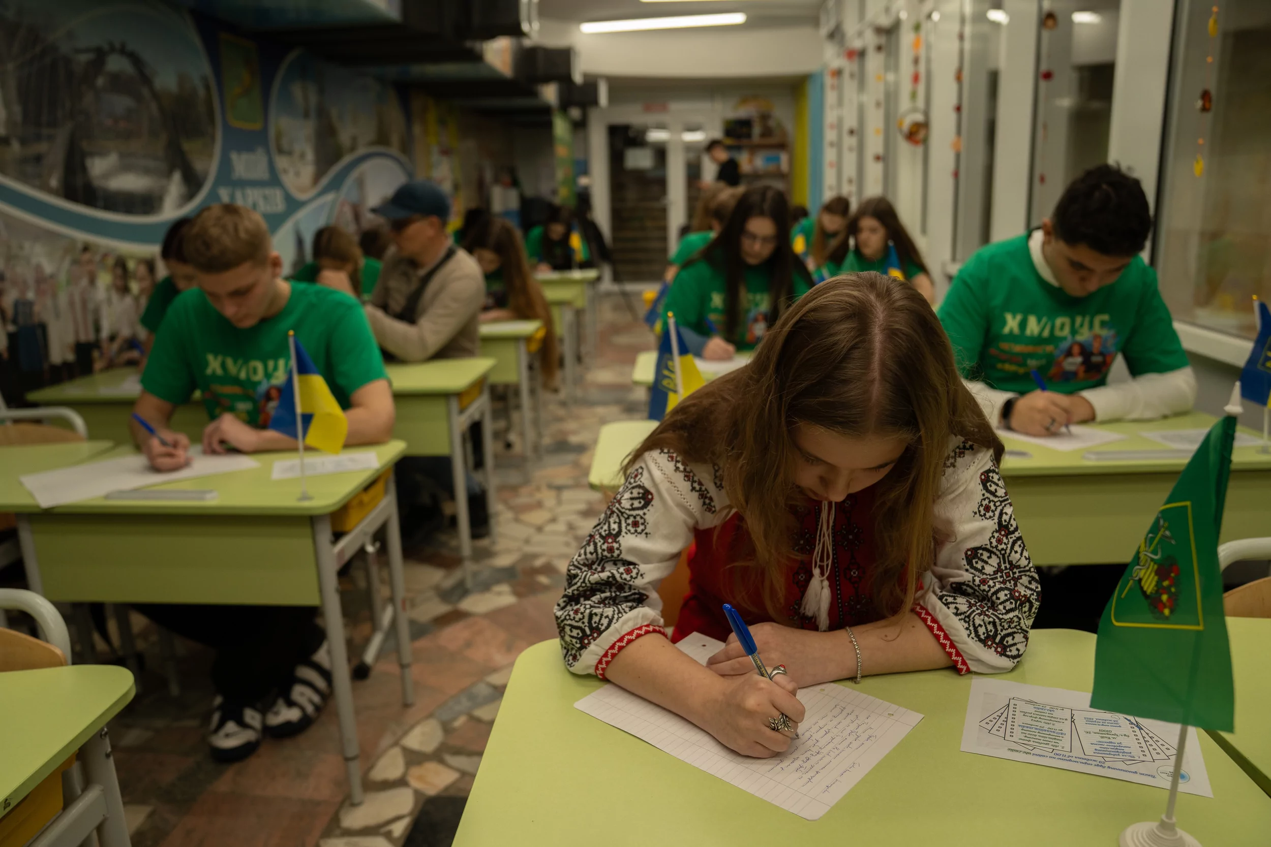 A pupil at the Kharkiv underground school in subway writes a dictation