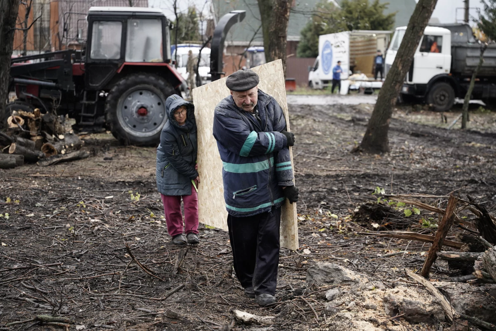 Kharkiv locals carry plywood to board up broken windows after Russian attack