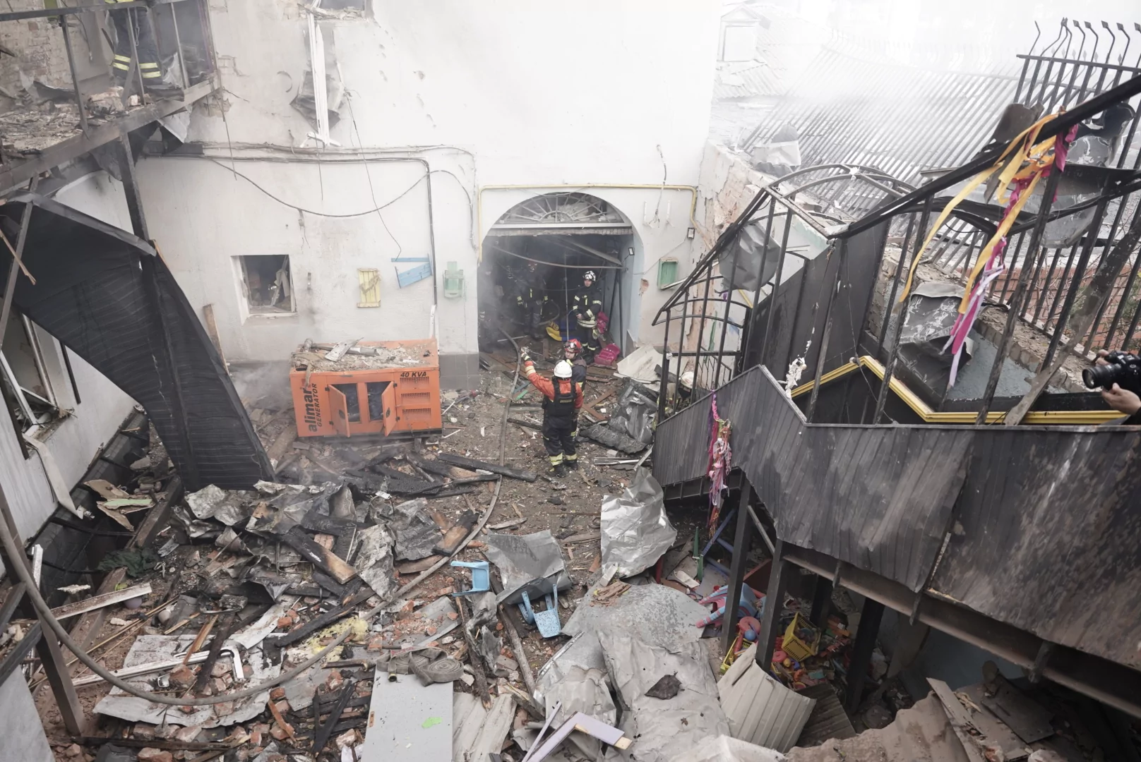 Rescuers inside of a Kharkiv private kindergarten destroyed by a Russian attack