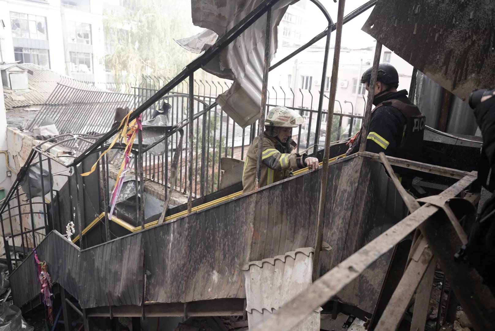 Emergency workers getting up the stairs at the impact site of Russian drone strike on Kharkiv, Oct. 22, 2025