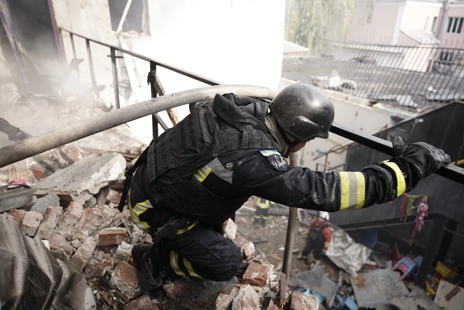 Emergency worker putting out a fire inside of a Kharkiv private kindergarten that was almost destroyed by the Russian drone strike