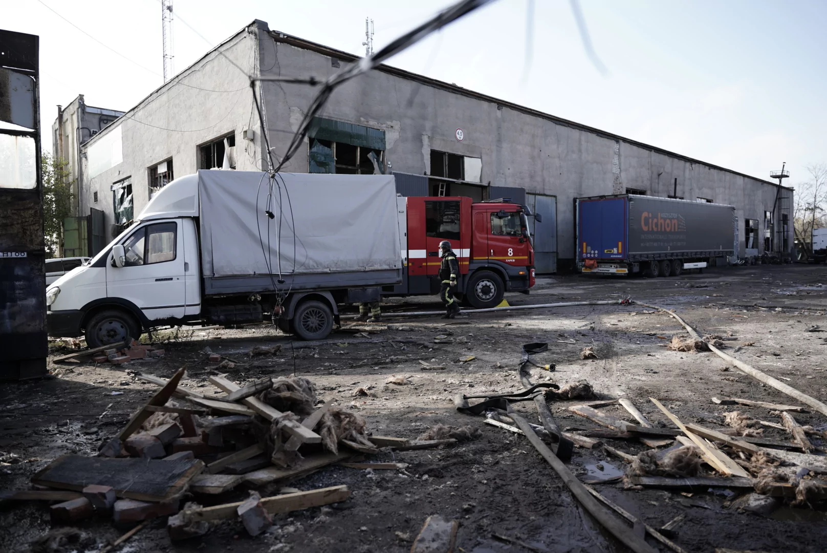Two trucks at the ompact site of the Russian glide bomb attack on Kharkiv on Oct. 24, 2025
