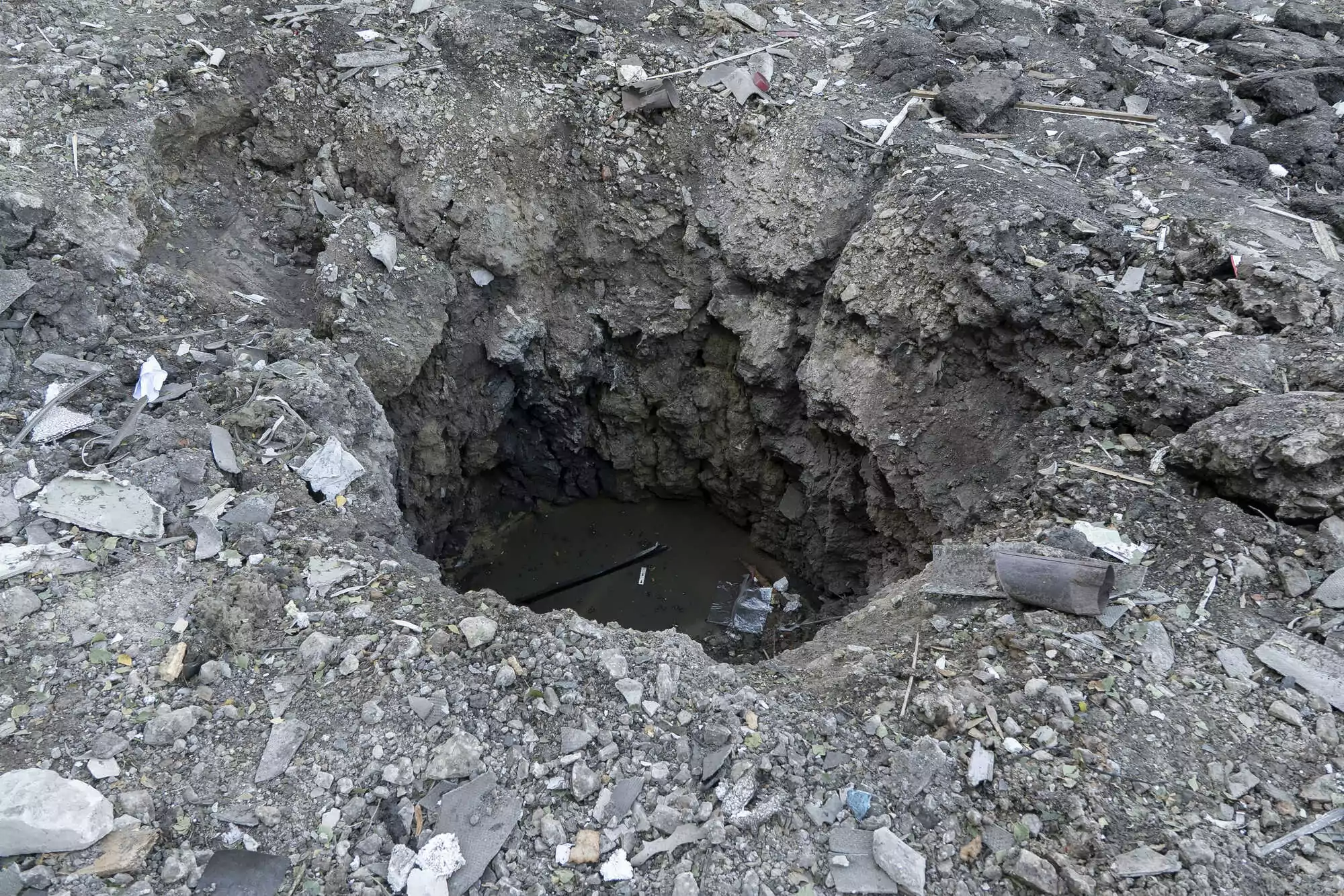 On October 1, Russian missile hit between the cage and apartment building leaving a crater