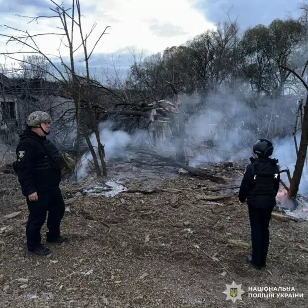Law enforcement at one of the hit sites of Russian airstrikes on Kharkiv oblast. The smoke from the attack still rising from the ground