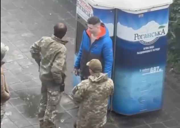 group of men in military uniform talking to a civilian man