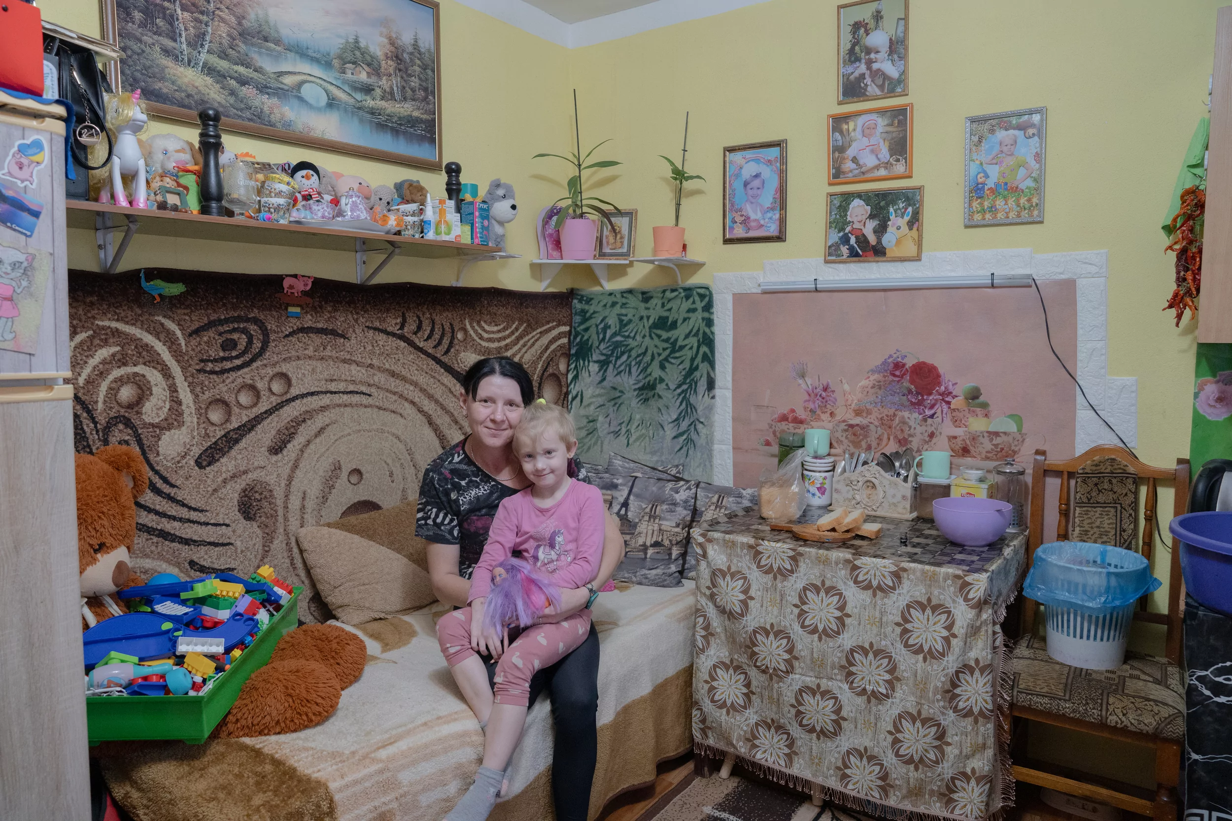 A woman with a child in dormitory for internally displaced people in Kharkiv