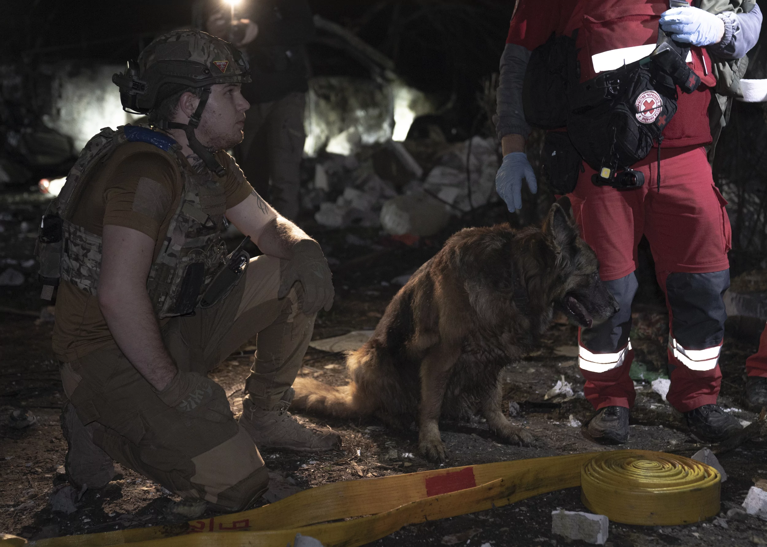 Emergency worker with a dog during a rescue operation after the Russian attack on Kharkiv