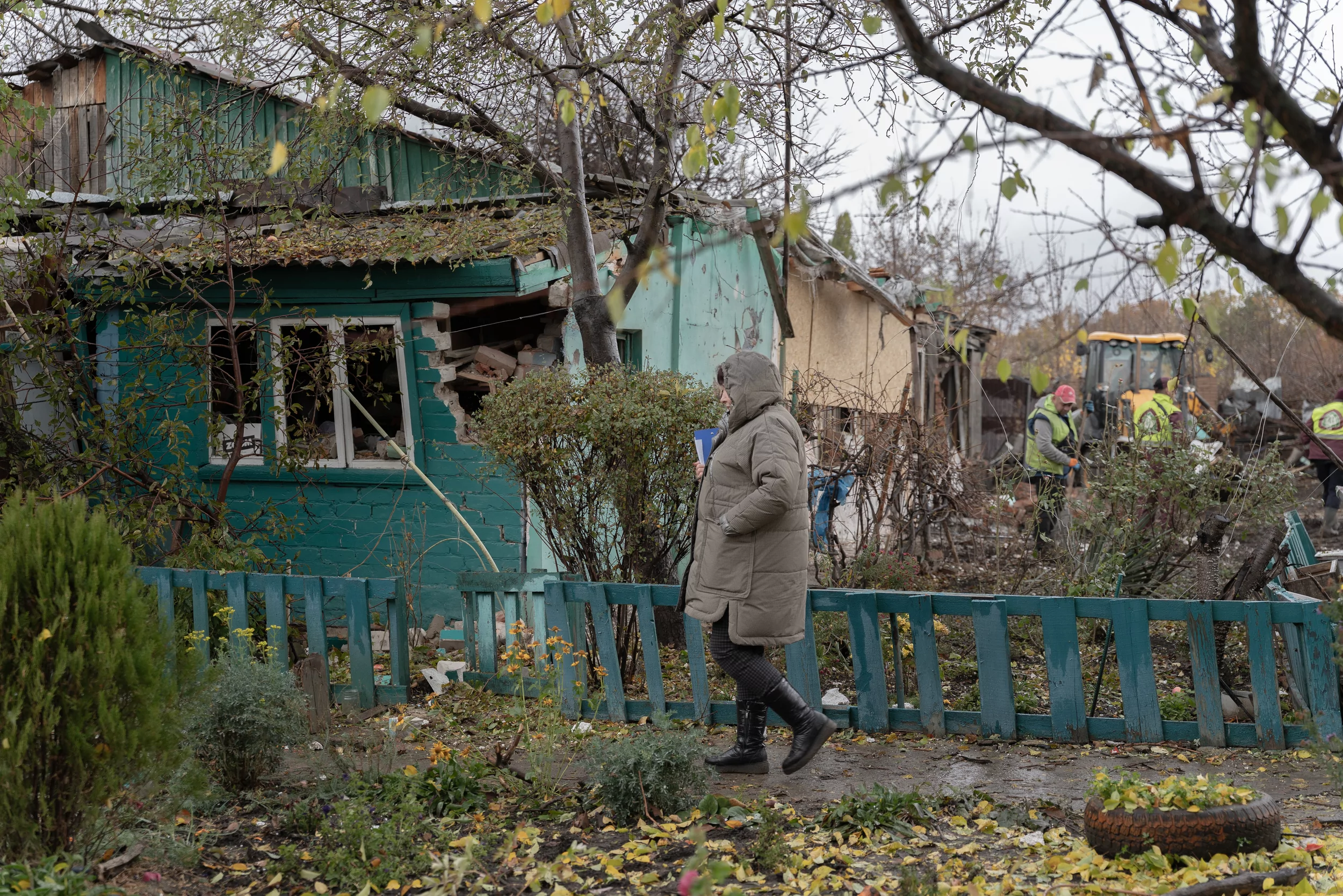 A woman near the damaged house after Russian attack on Kharkiv