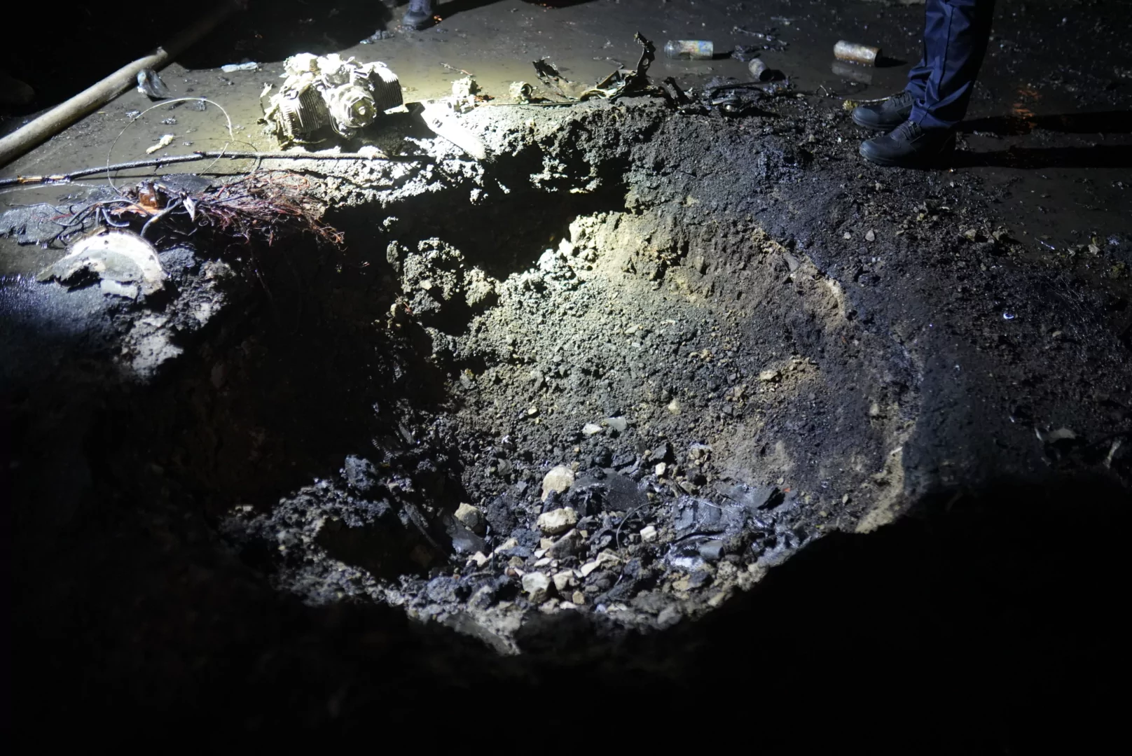 A hole in the ground after a Russian drone attack on Kharkiv